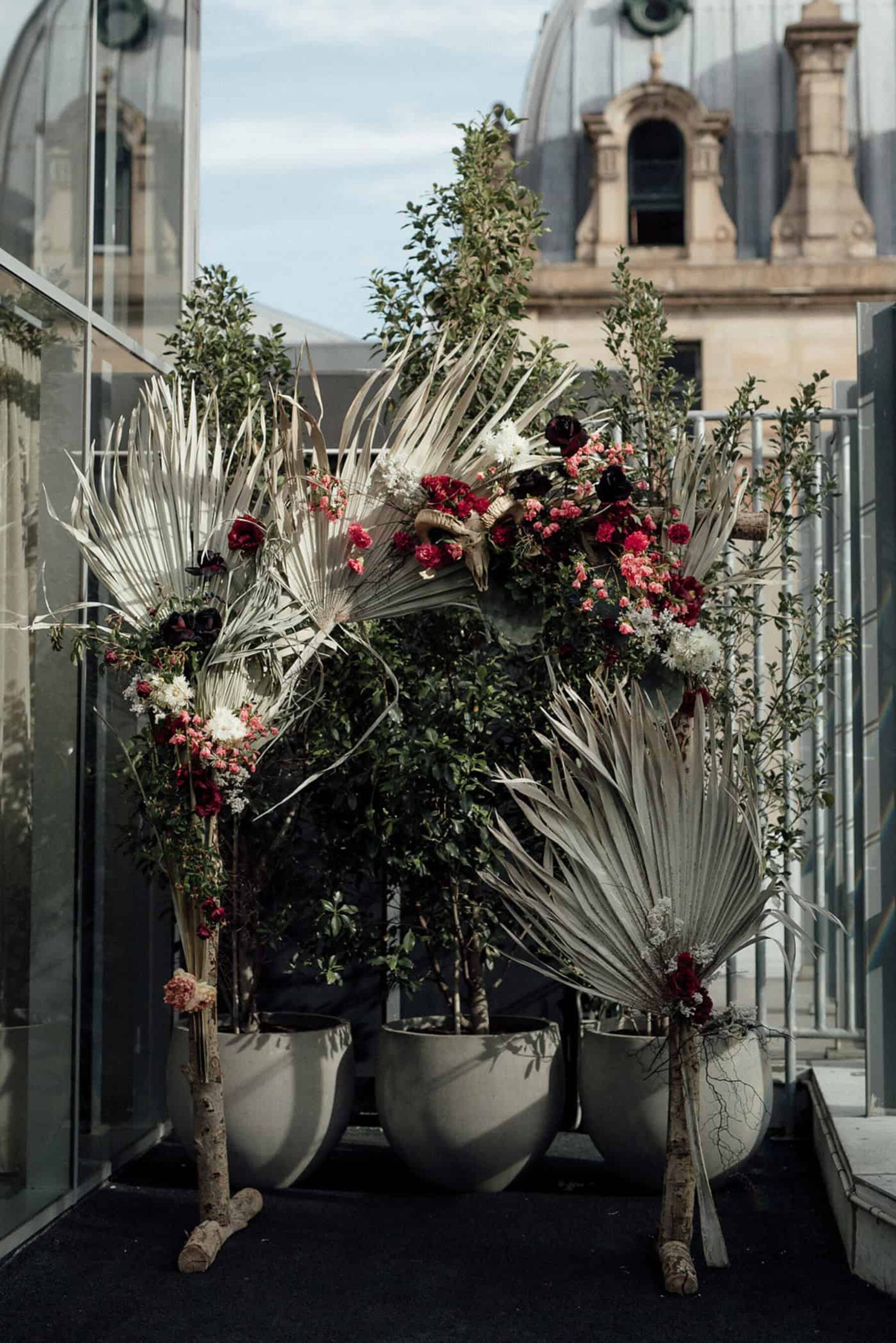structural floral arbour with dried palms