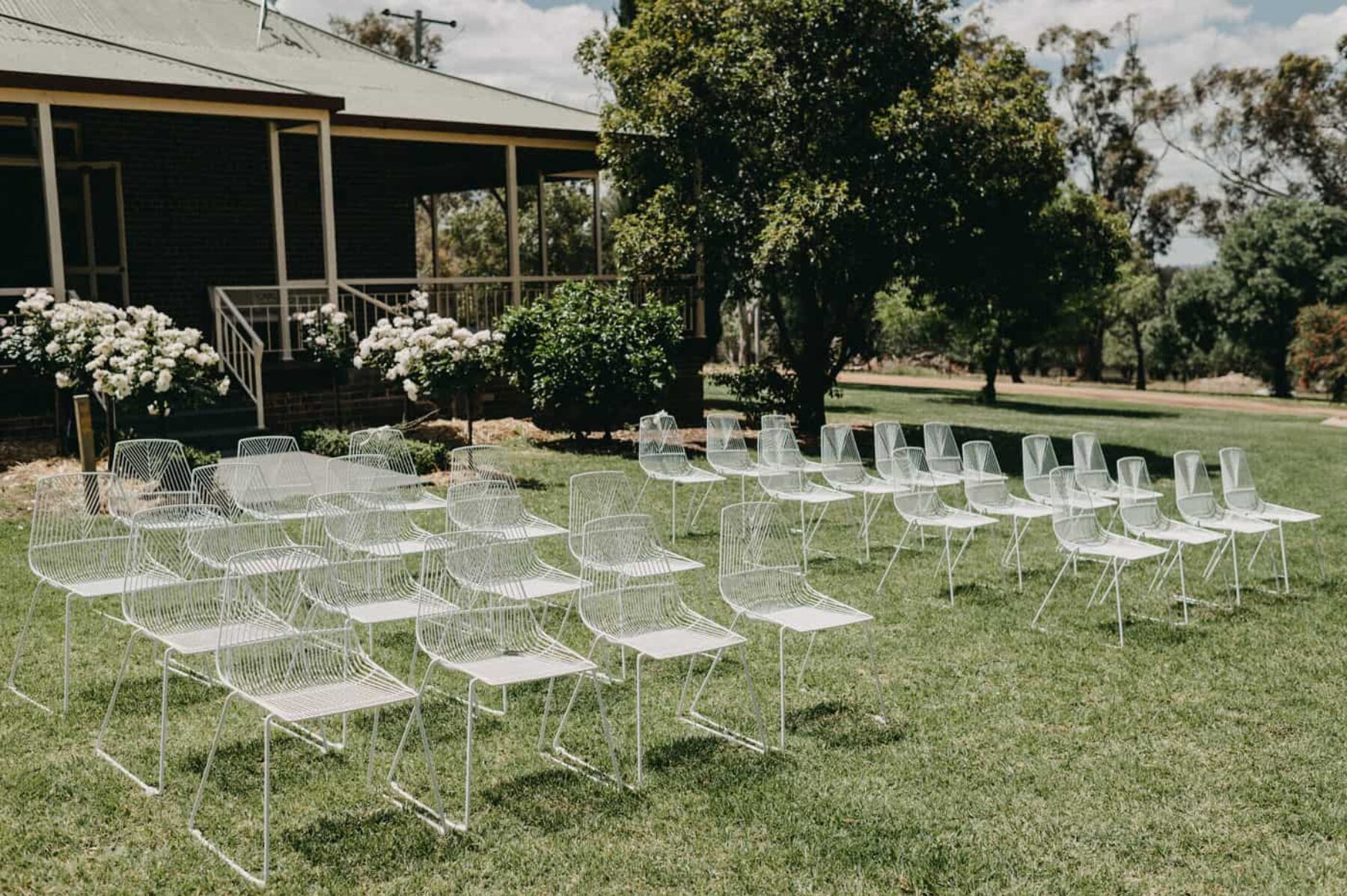 modern white wire chairs wedding ceremony