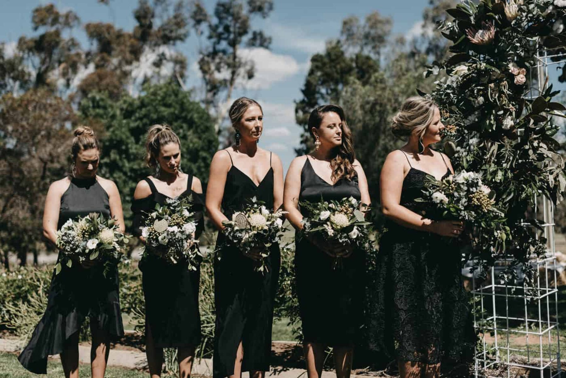 bridesmaids in mixed modern black dresses