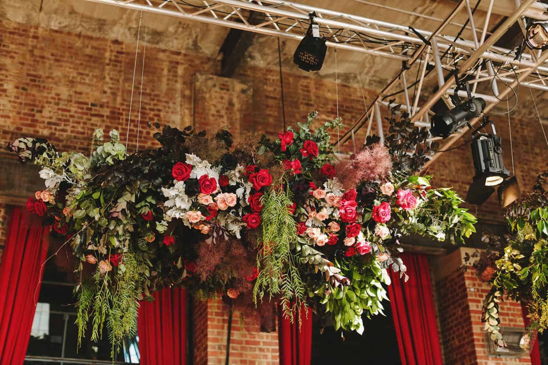 hanging floral installation in jewel tones and black roses