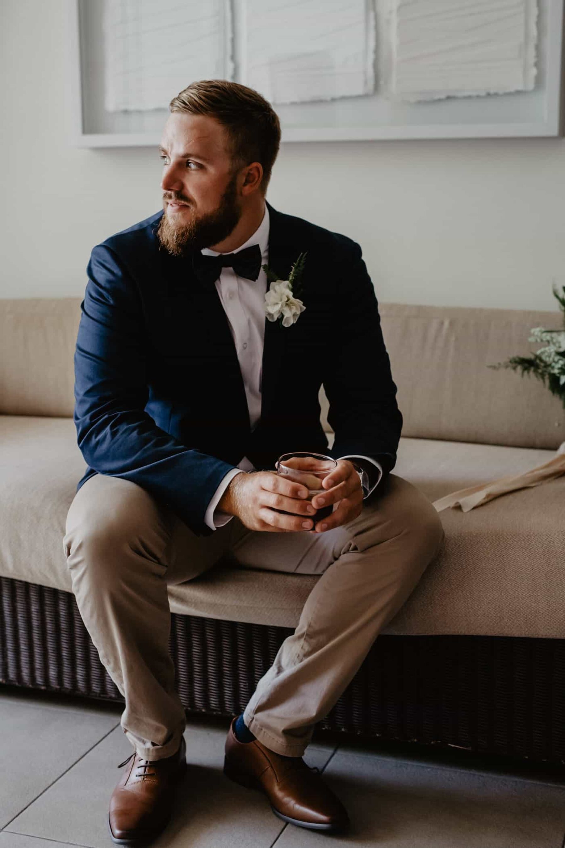 groom in navy blazer and tan chinos