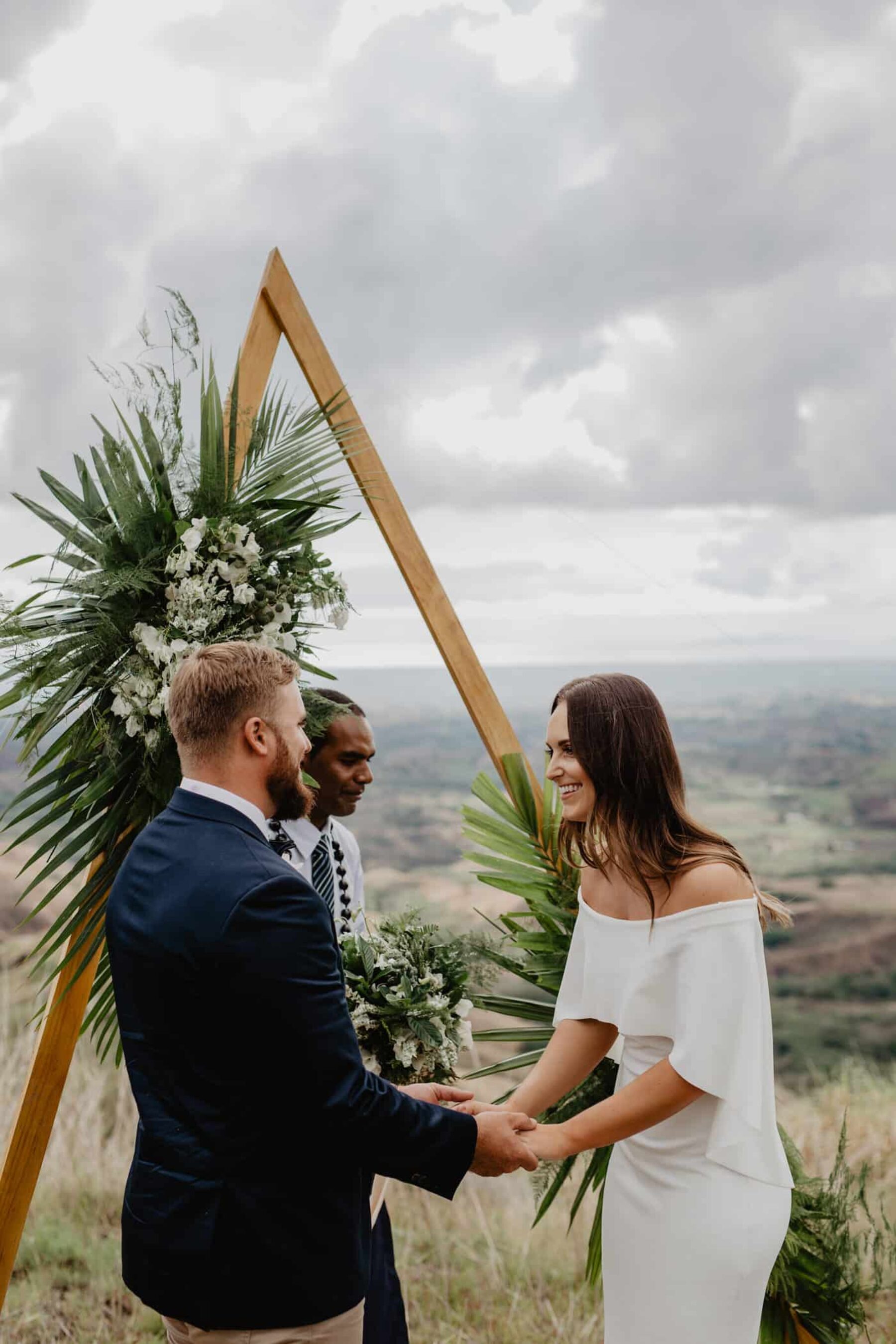 geometric triangle wedding arbour with tropical greenery