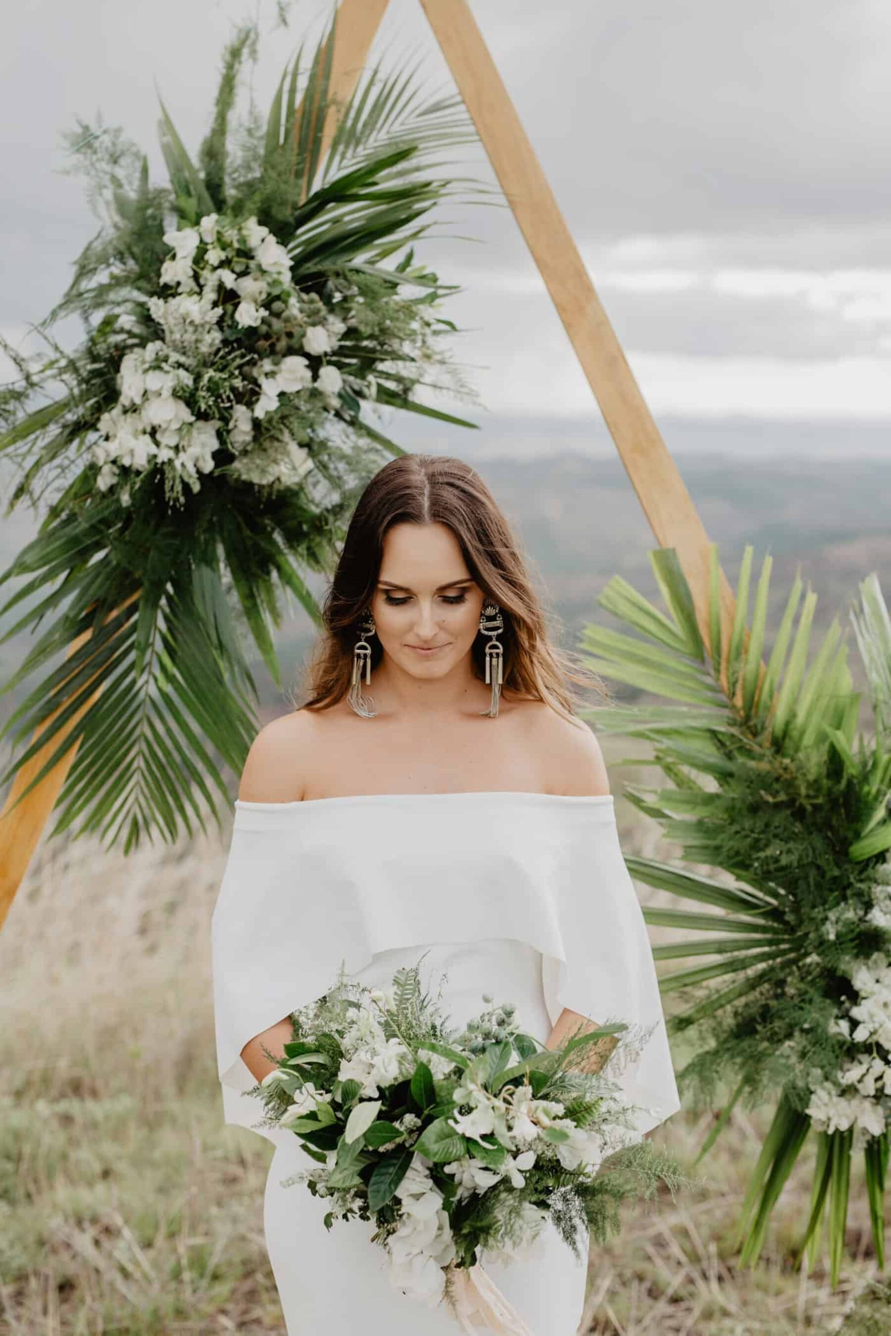 geometric triangle wedding arbour with tropical greenery