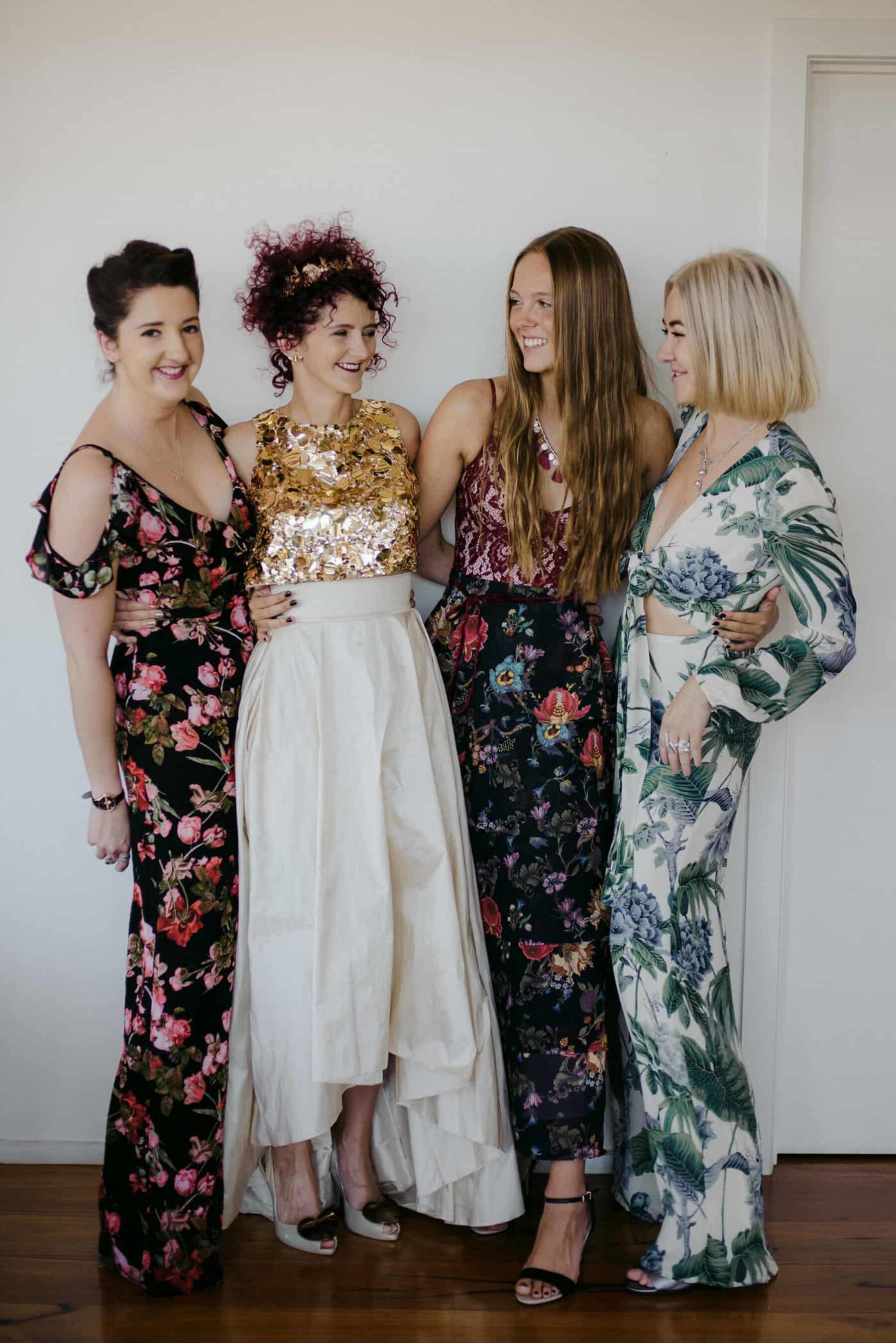 bridemaids in mismatched floral maxi dresses and jumpsuit