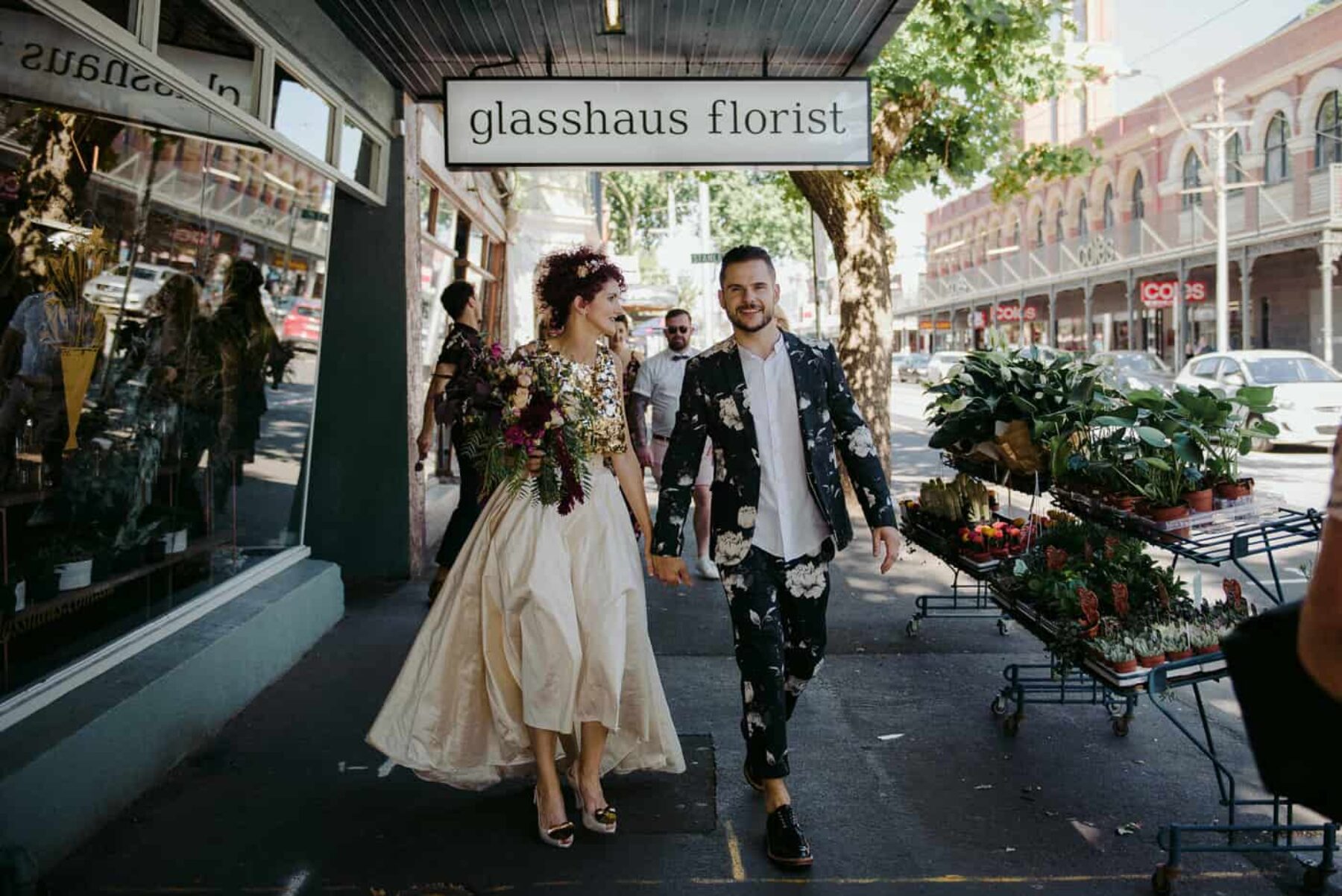 unique bride in gold two-piece wedding dress + groom in floral suit