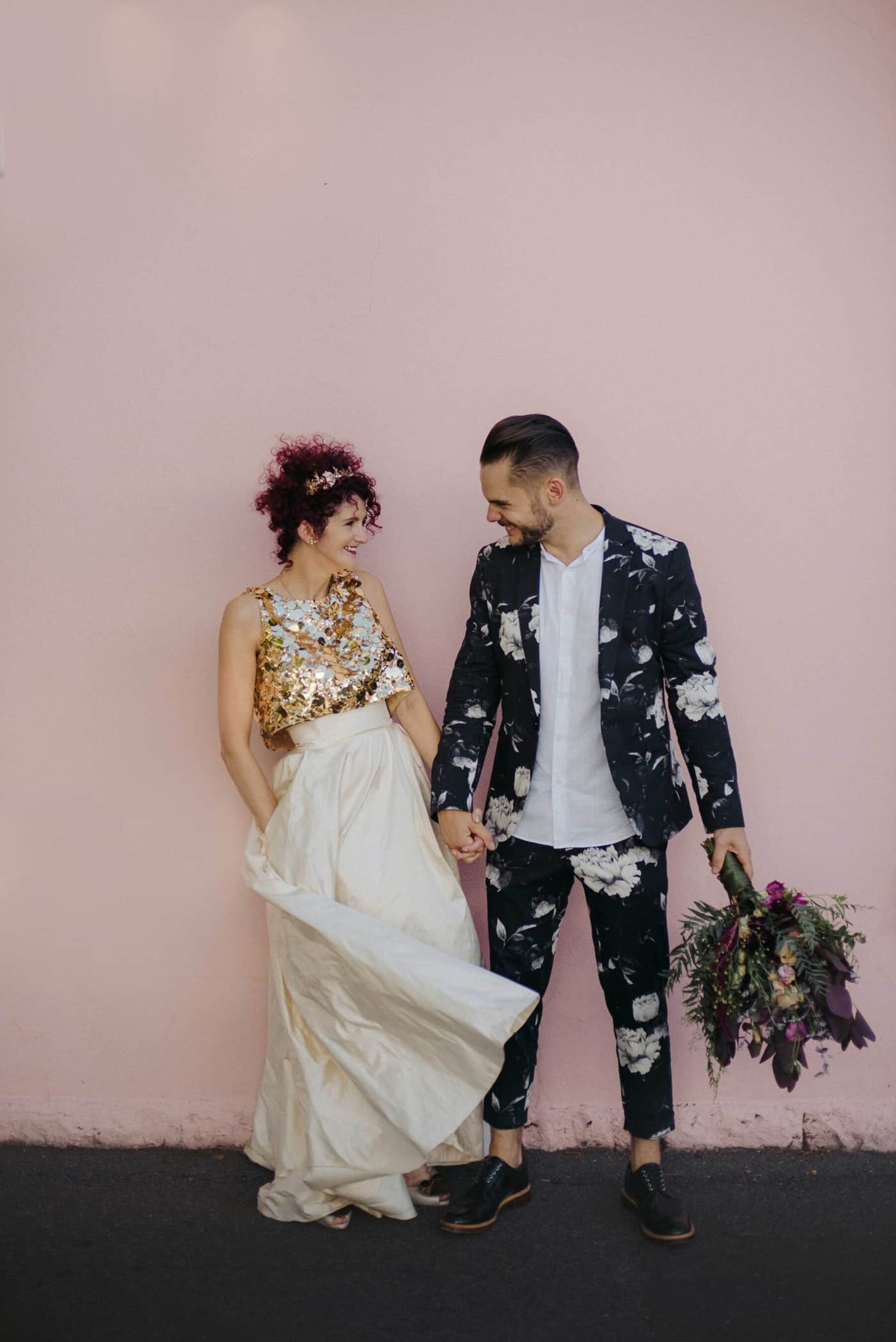 unique bride in gold two-piece wedding dress + groom in floral suit