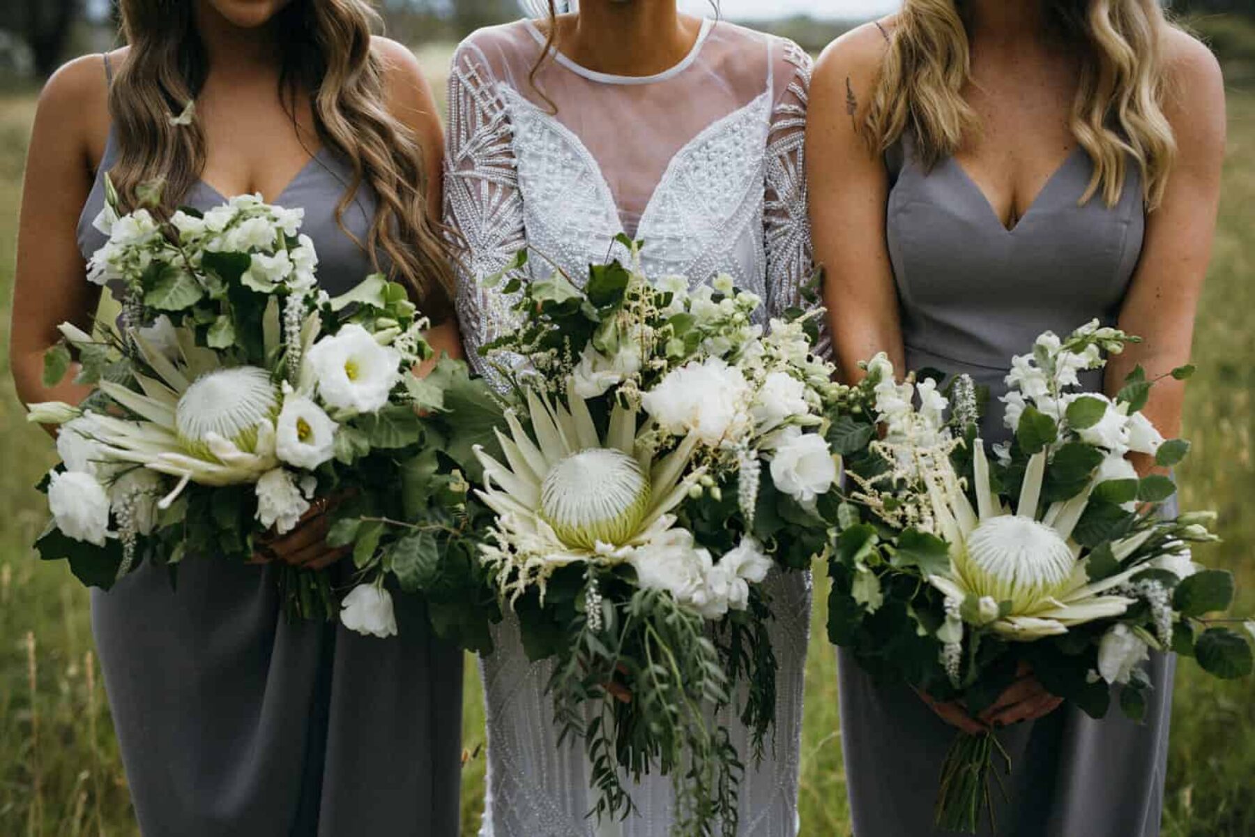dove grey bridesmaid dresses and green and white bouquets