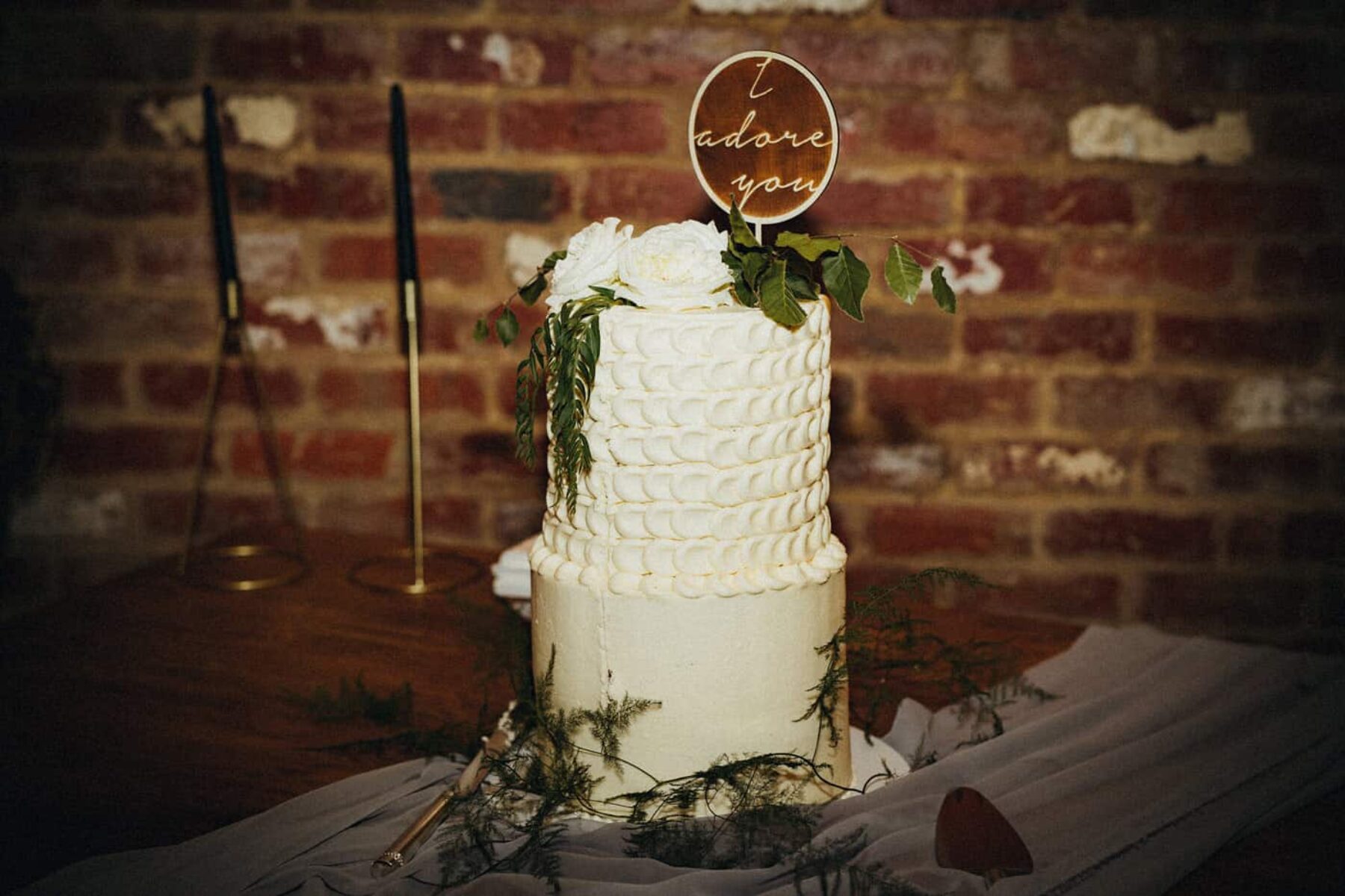 white wedding cake with foliage
