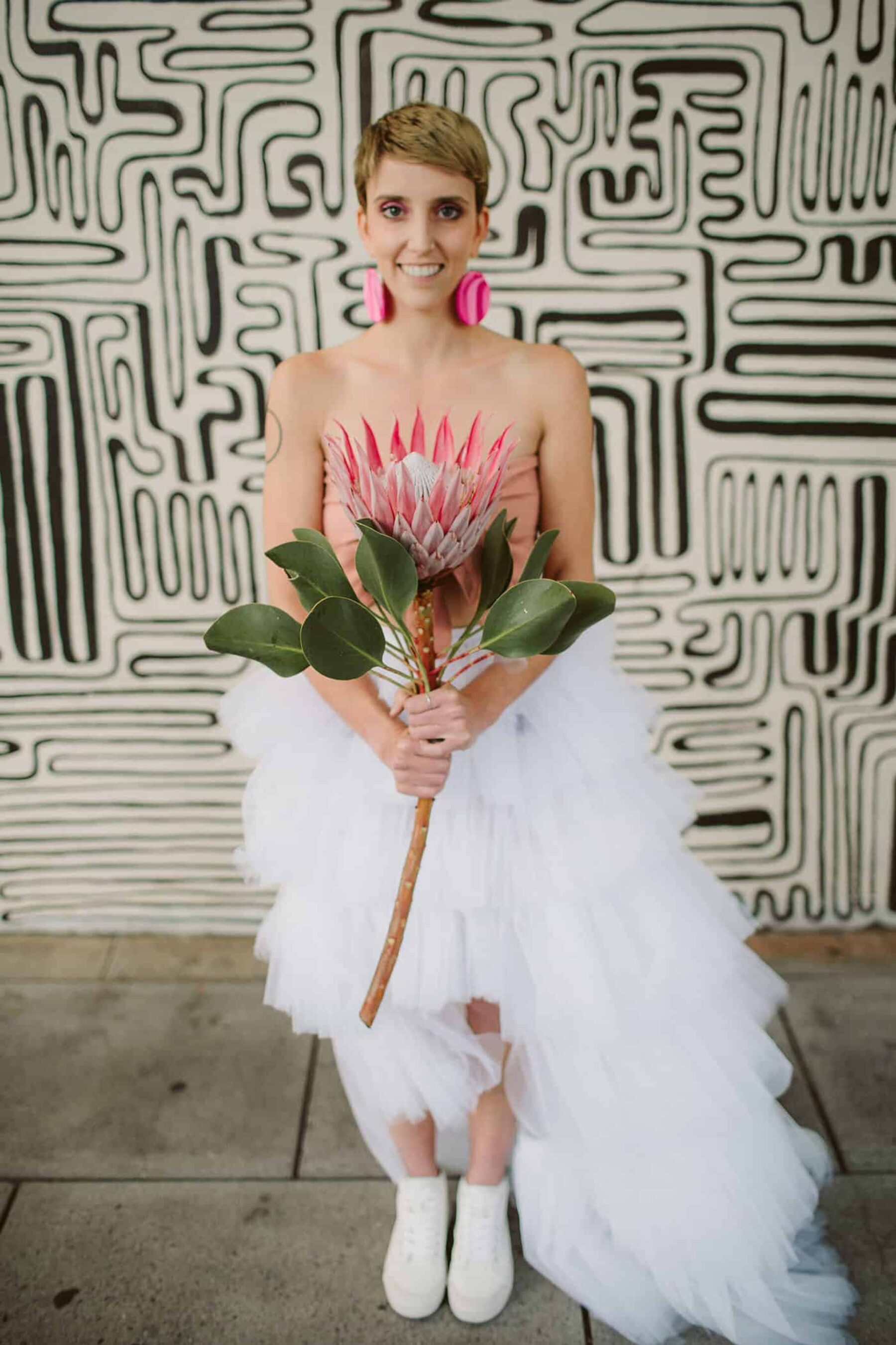 quirky bride with single king protea bouquet
