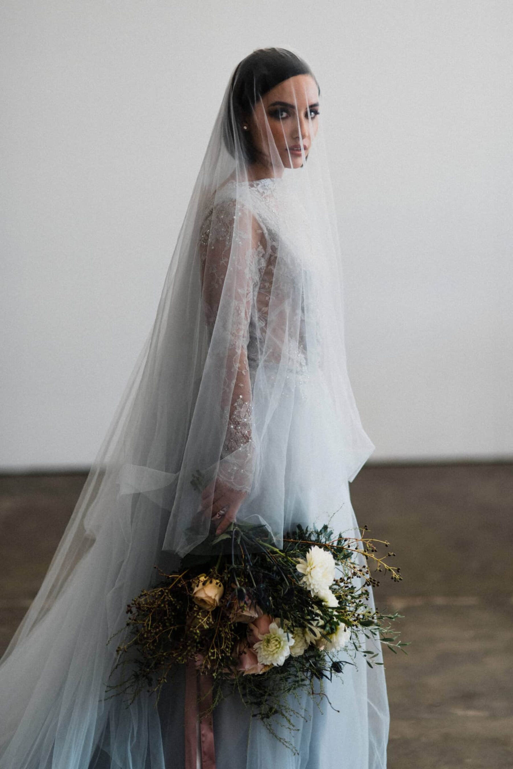 bride in dove blue lace wedding dress and veil