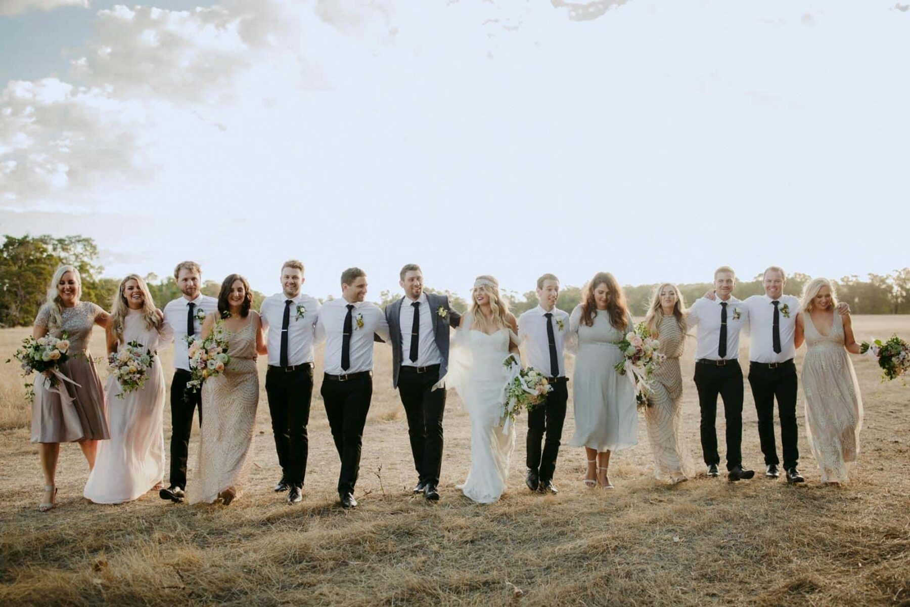 Gatsby inspired bridal party with mismatched neutral bridesmaid dresses
