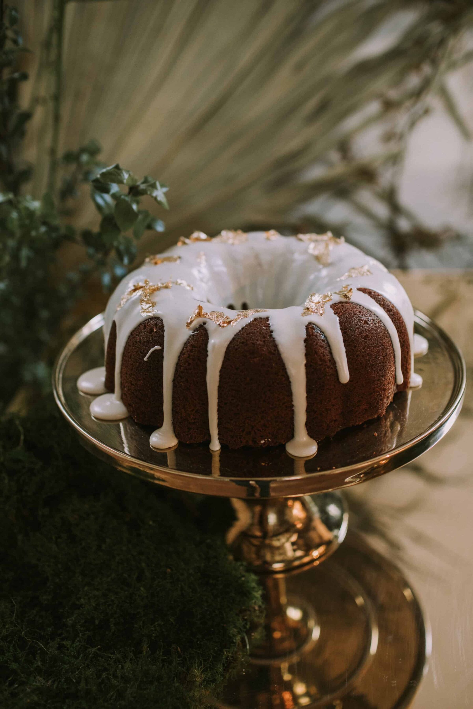bundt cake with drip icing and gold leaf