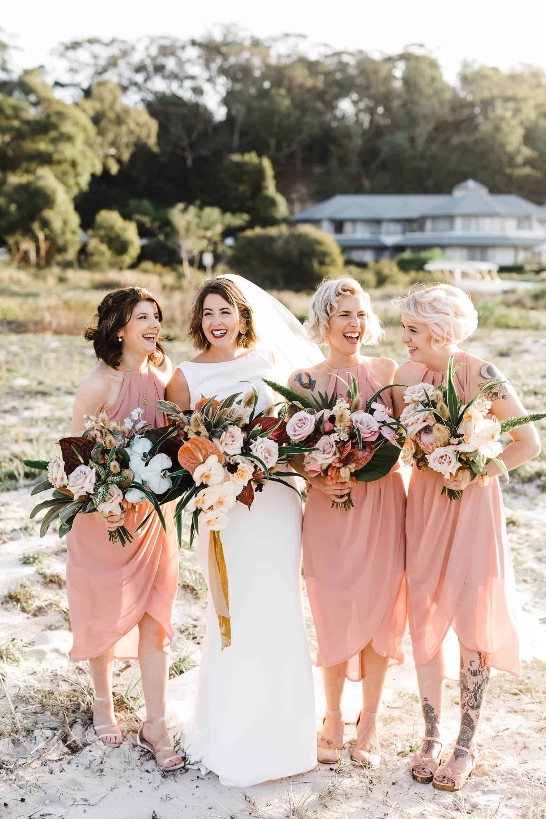 blush bridesmaid dresses and tropical bouquets