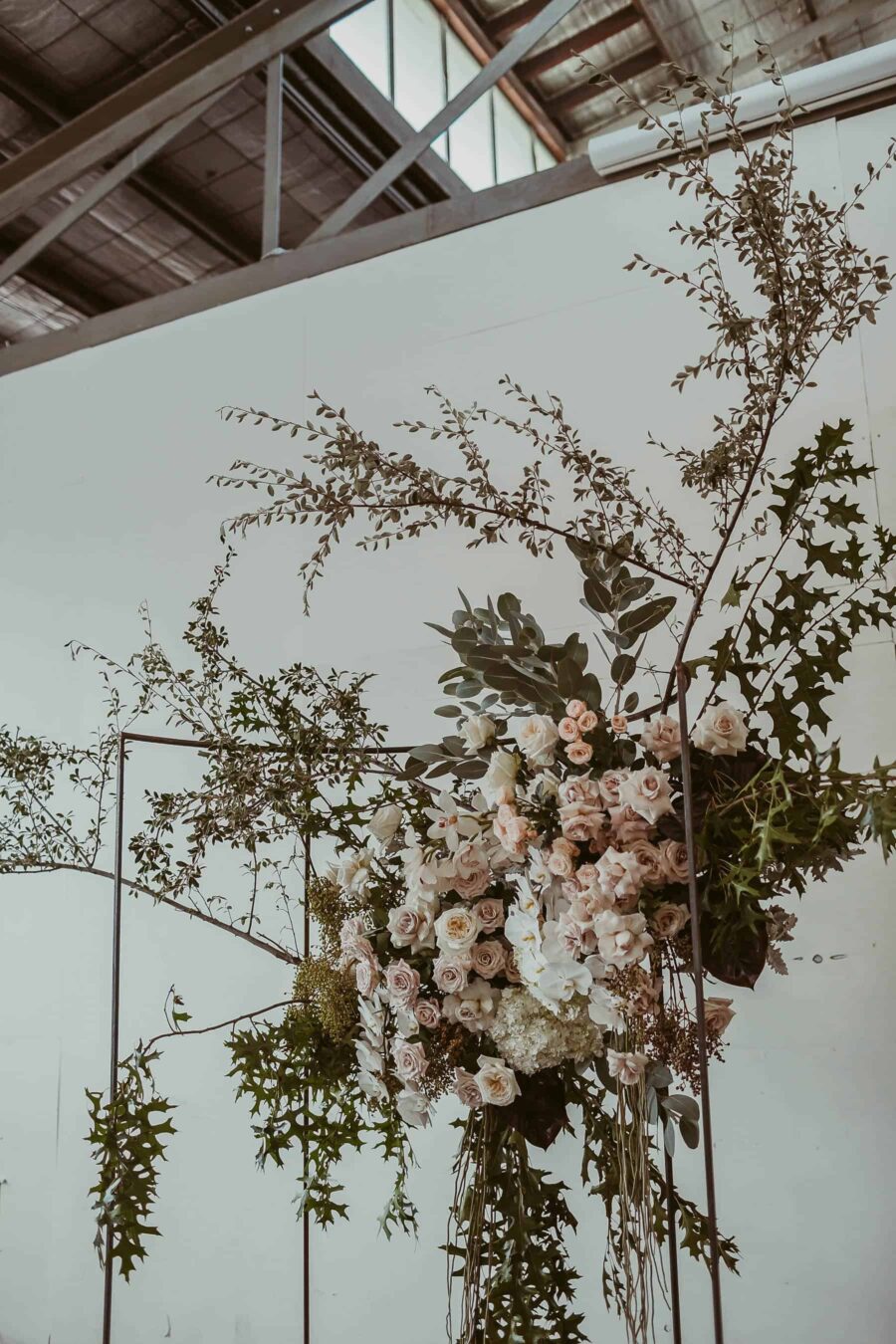 modern blush floral installation with roses and orchids