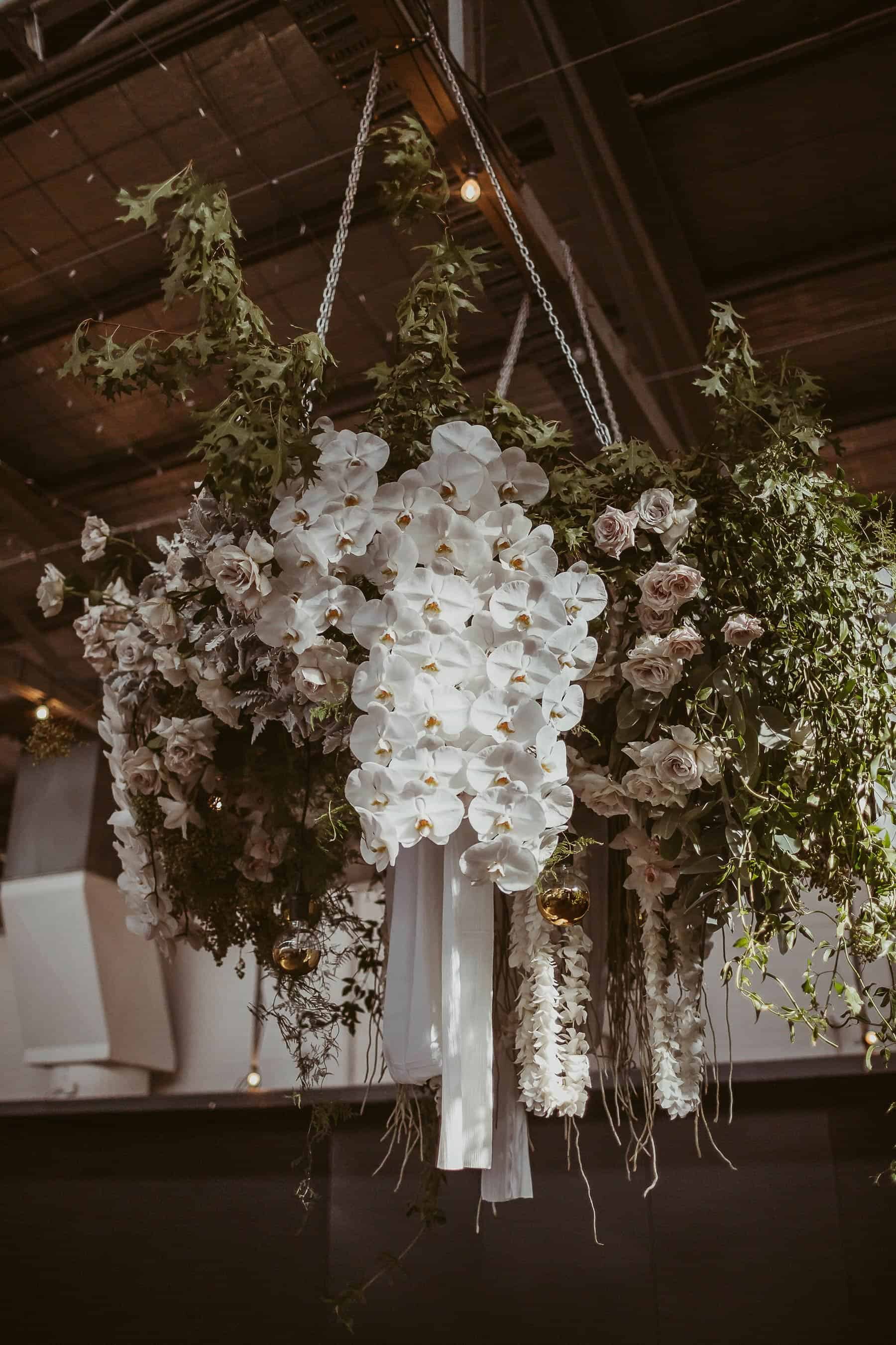 modern blush floral installation with roses and orchids