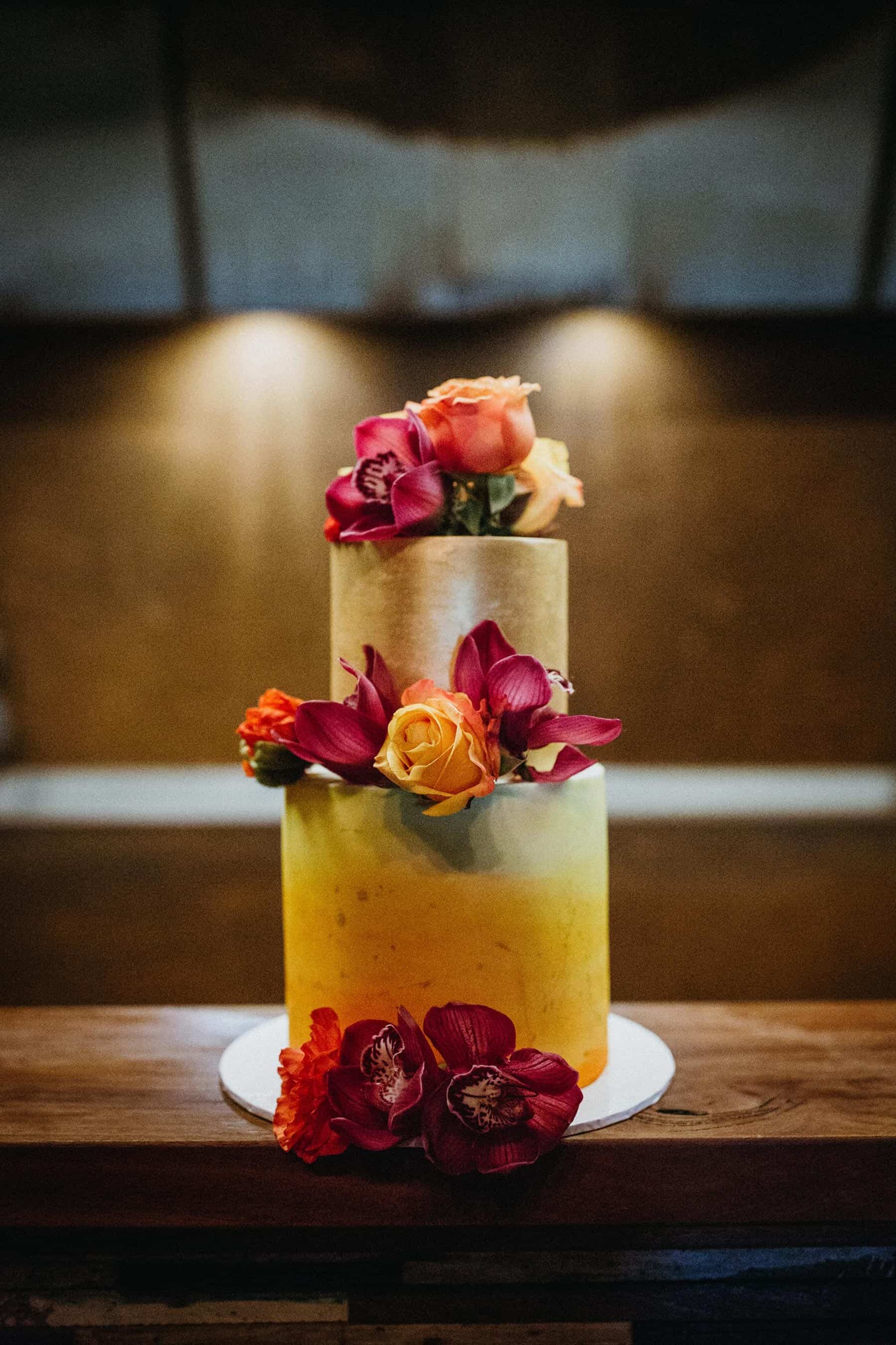 ombre gold wedding cake with fresh pink flowers