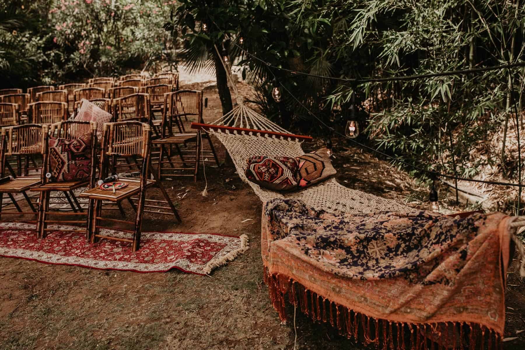 rustic bamboo chairs and hammock for a boho wedding ceremony