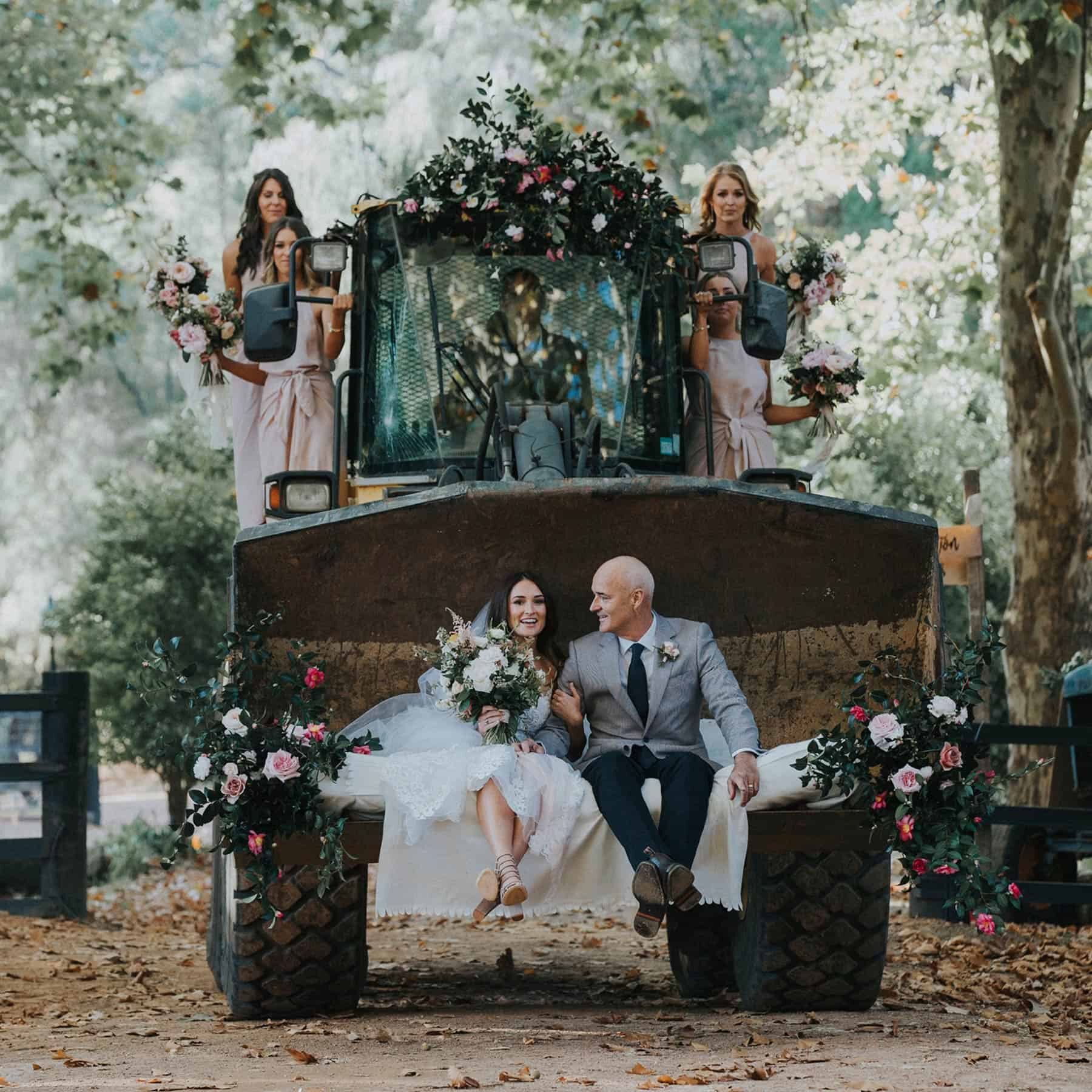 bridal party arriving on a flower-laden tractor
