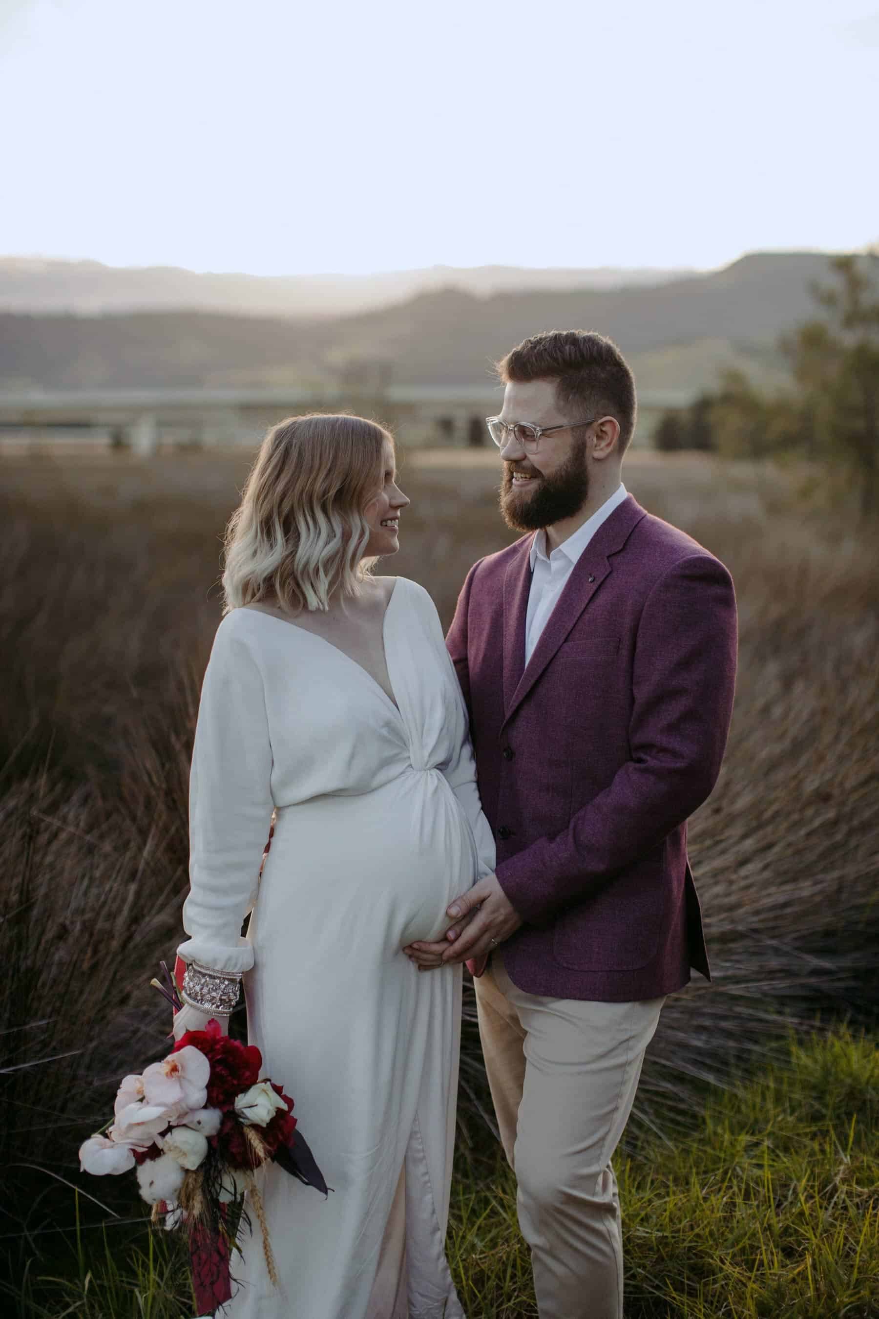 pregnant bride in modern long sleeve wedding dress by Bo & Luca