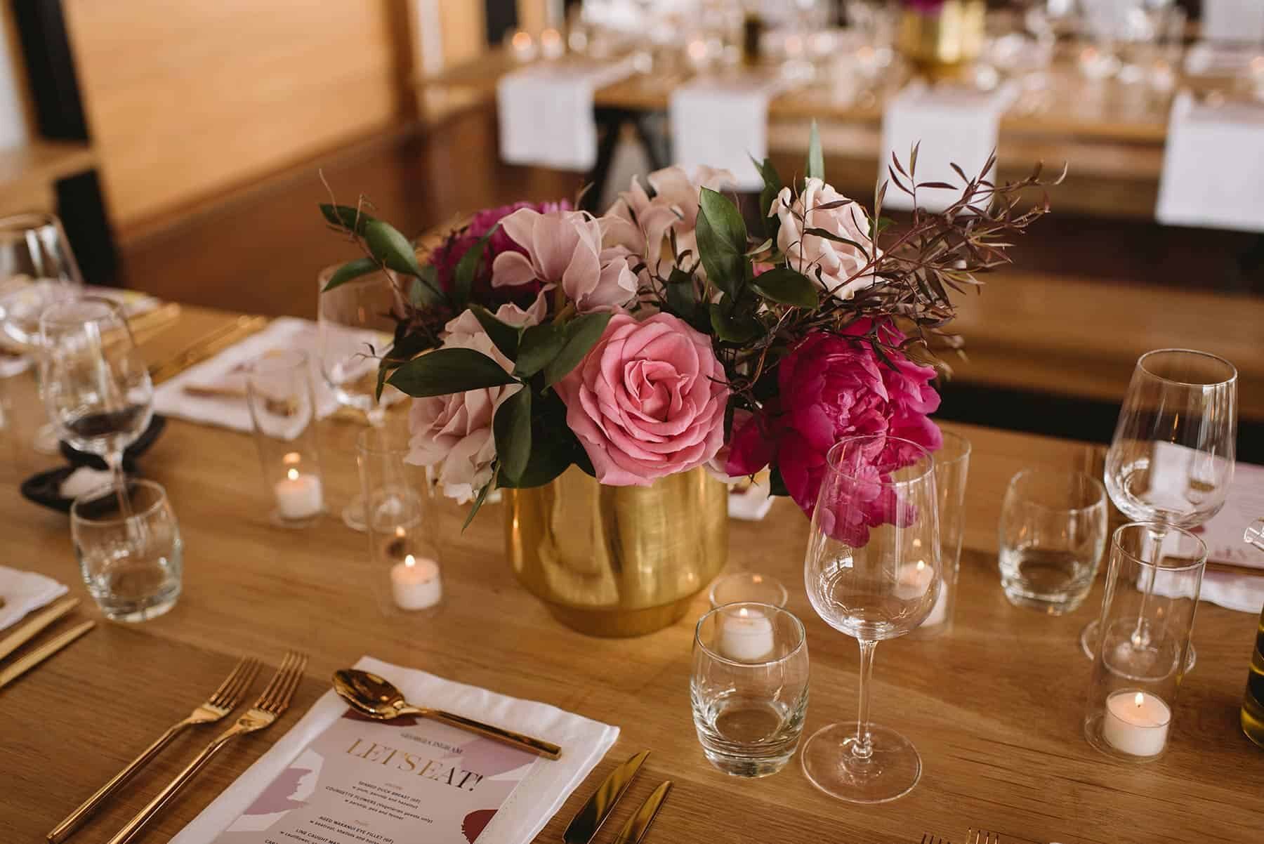 pink table flowers in gold vase
