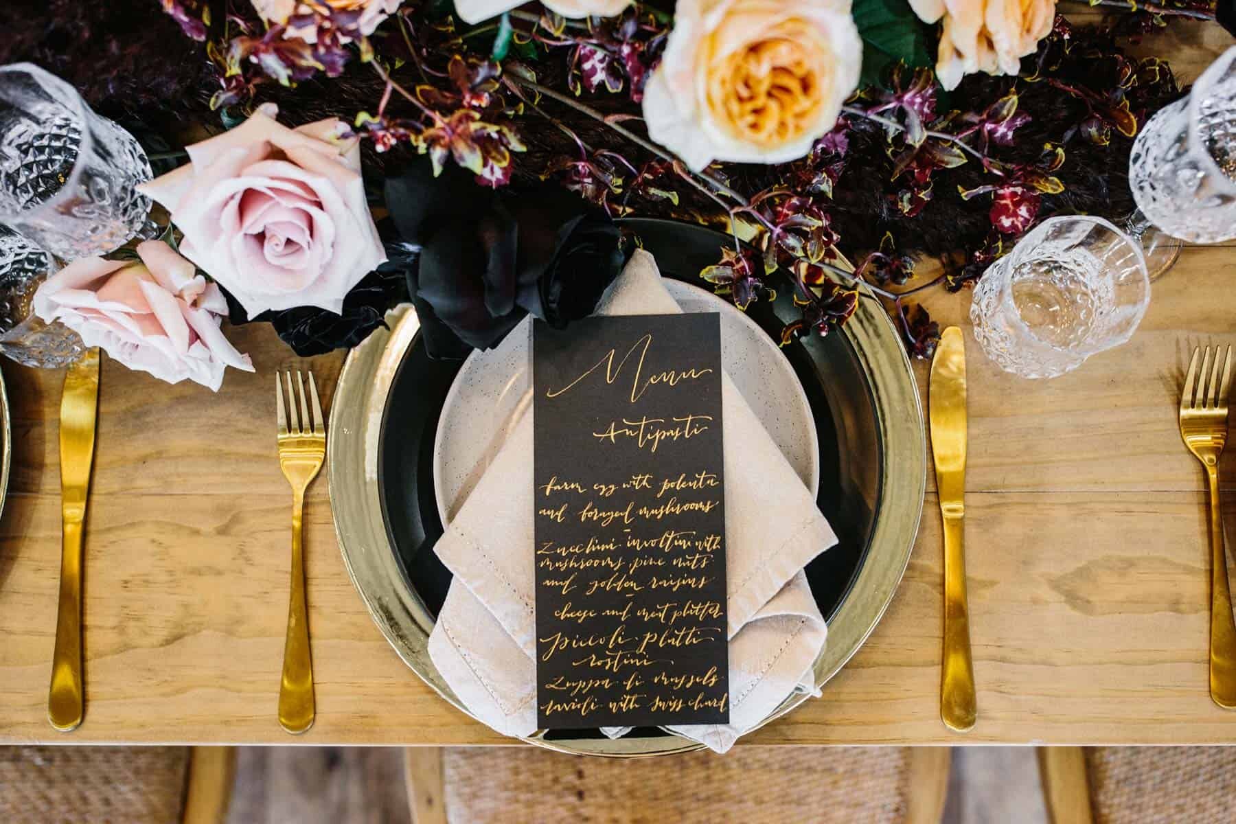 modern tablescape with blush and burgundy flowers