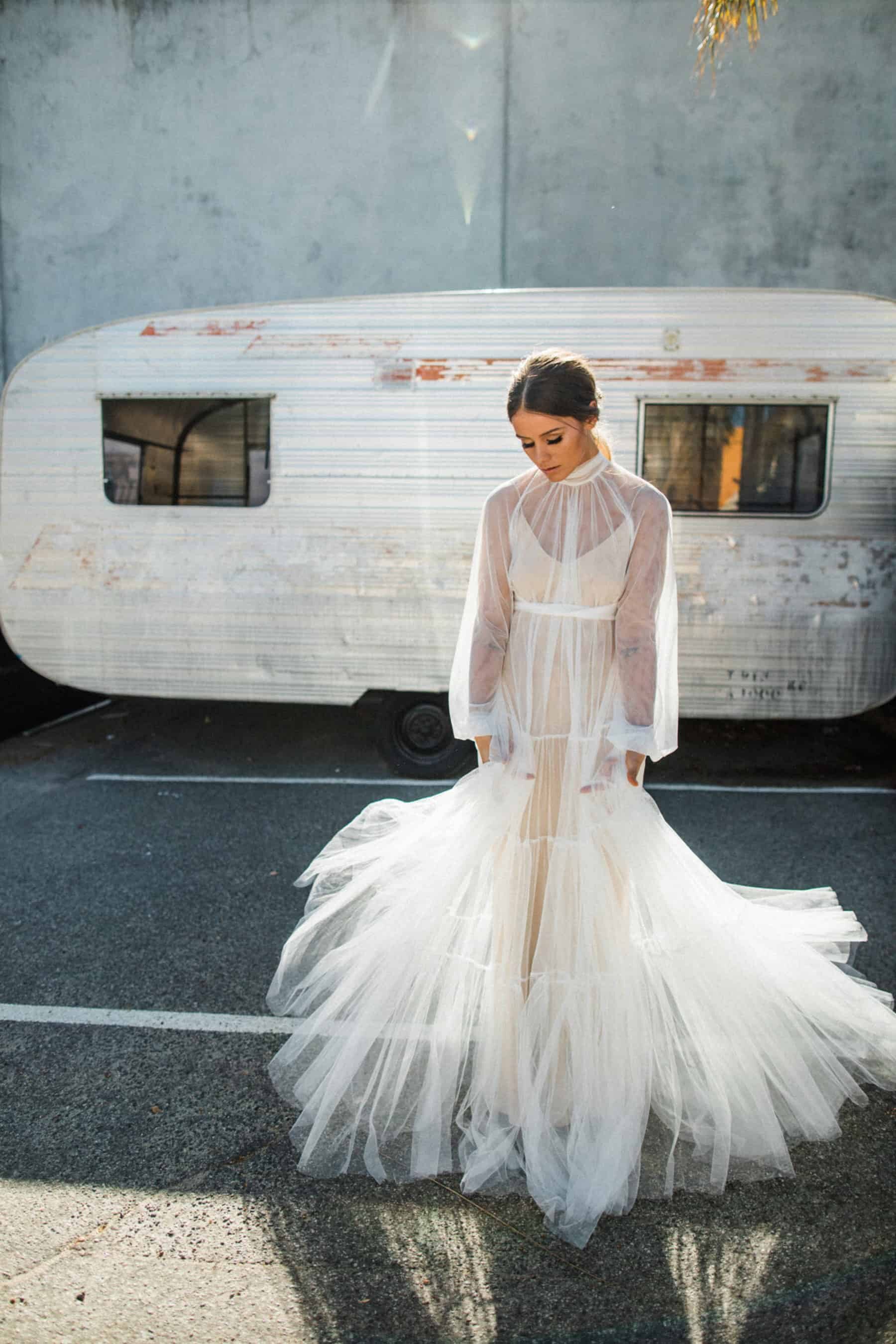 soft tulle gown with high neckline, billowing bishop sleeve and buttoned cuff