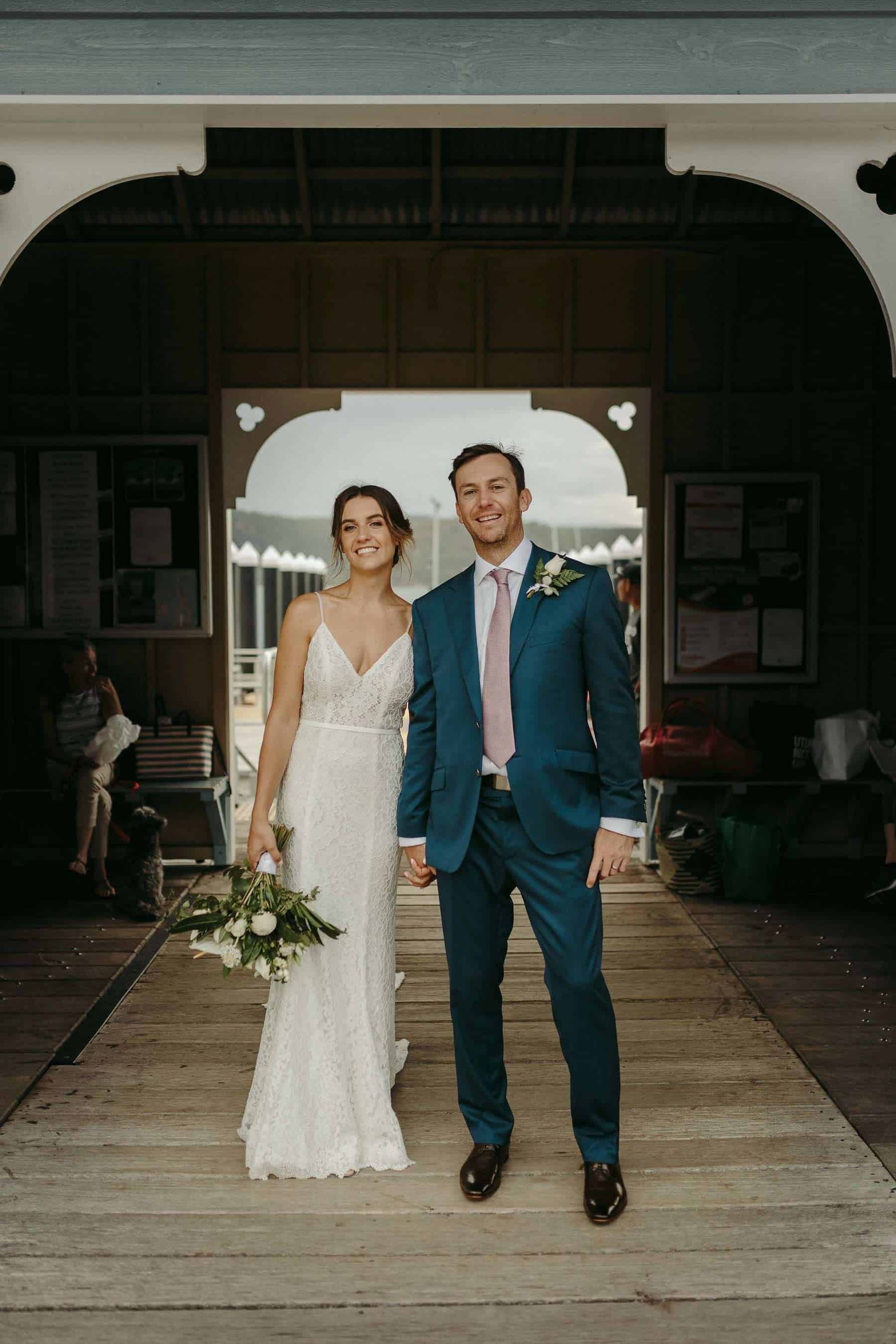 Grace loves lace gown and navy suit at beach wedding