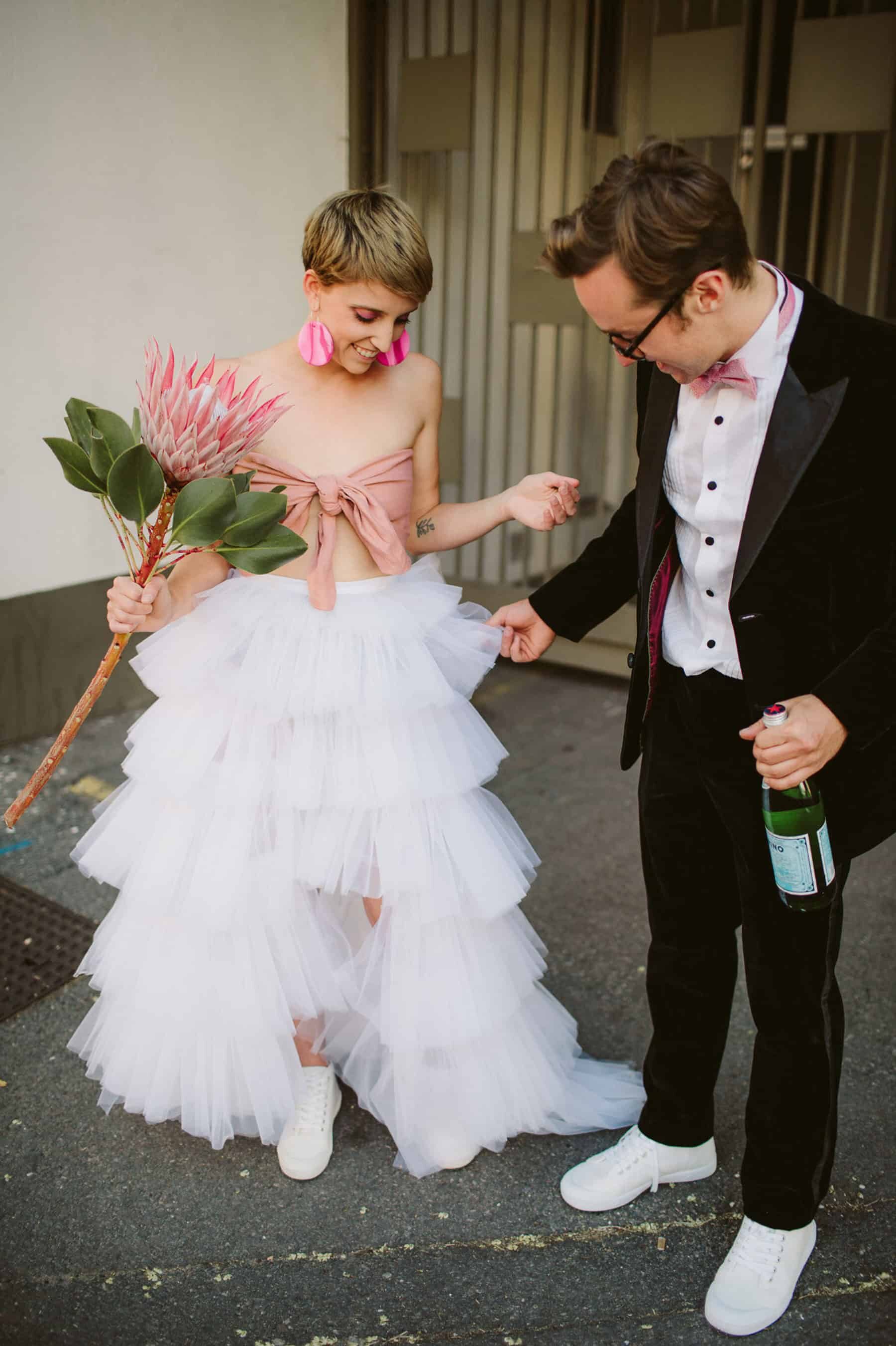 quirky bride in tiered tulle two-piece wedding dress with pink bandeau top