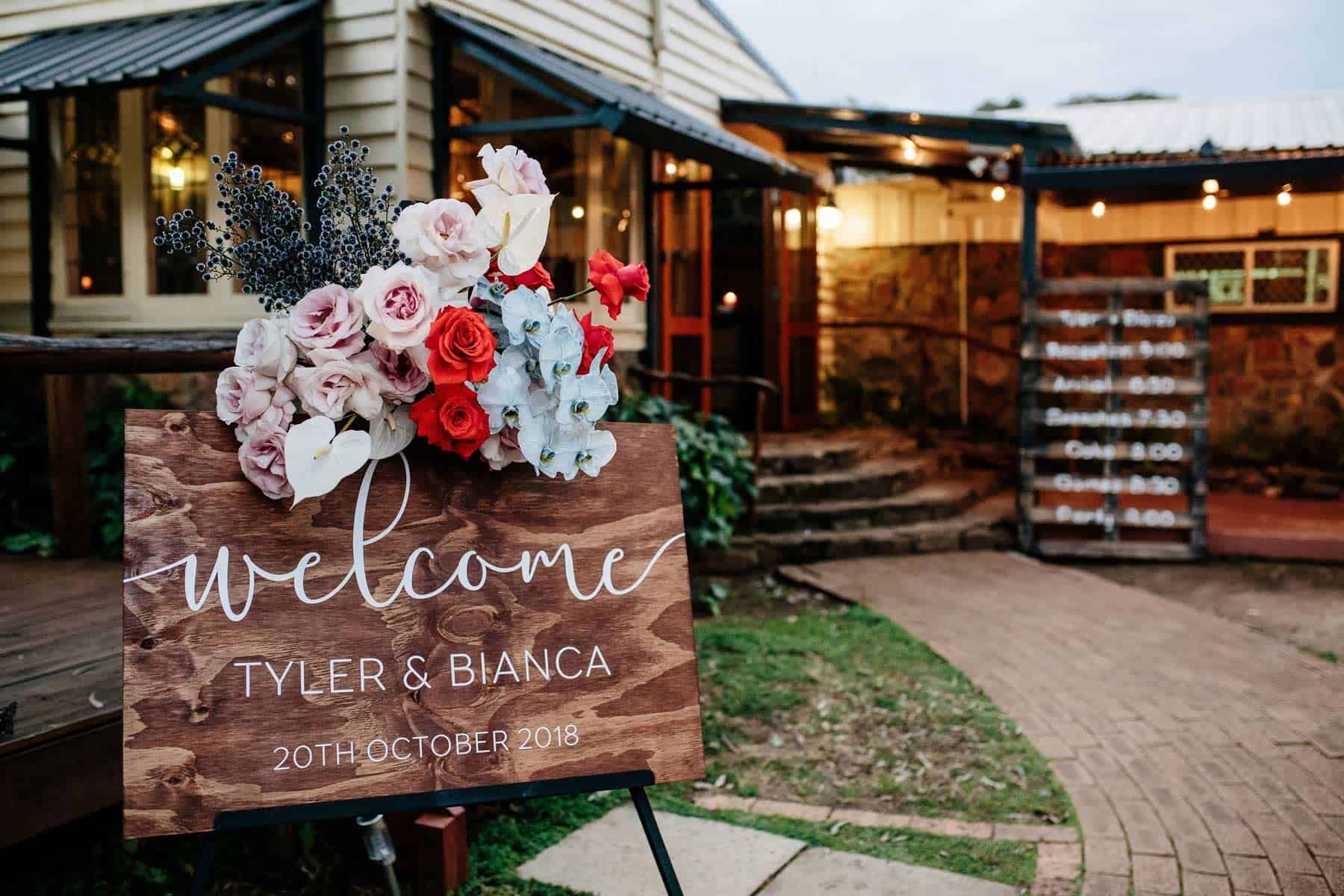 Wooden welcome sign with colourful roses