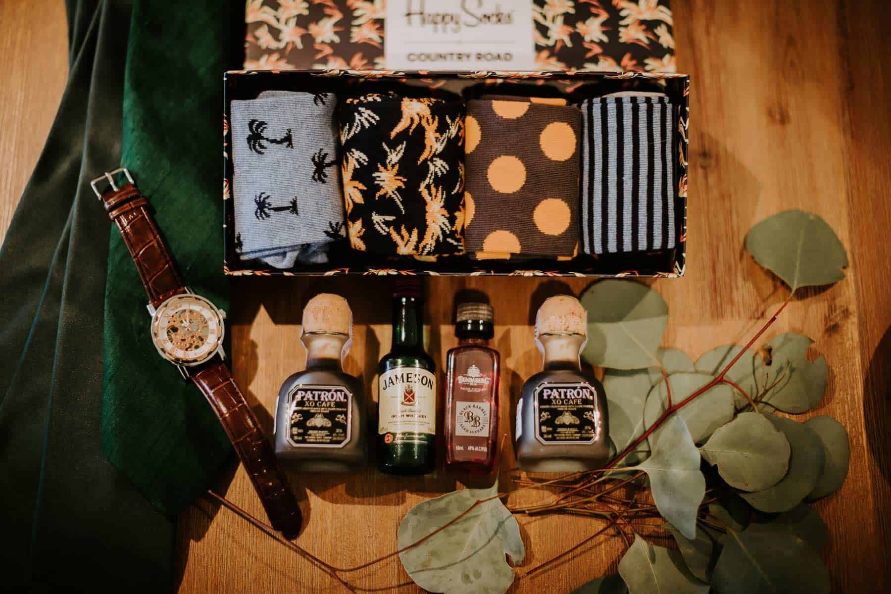 groom flatlay with whiskey and socks