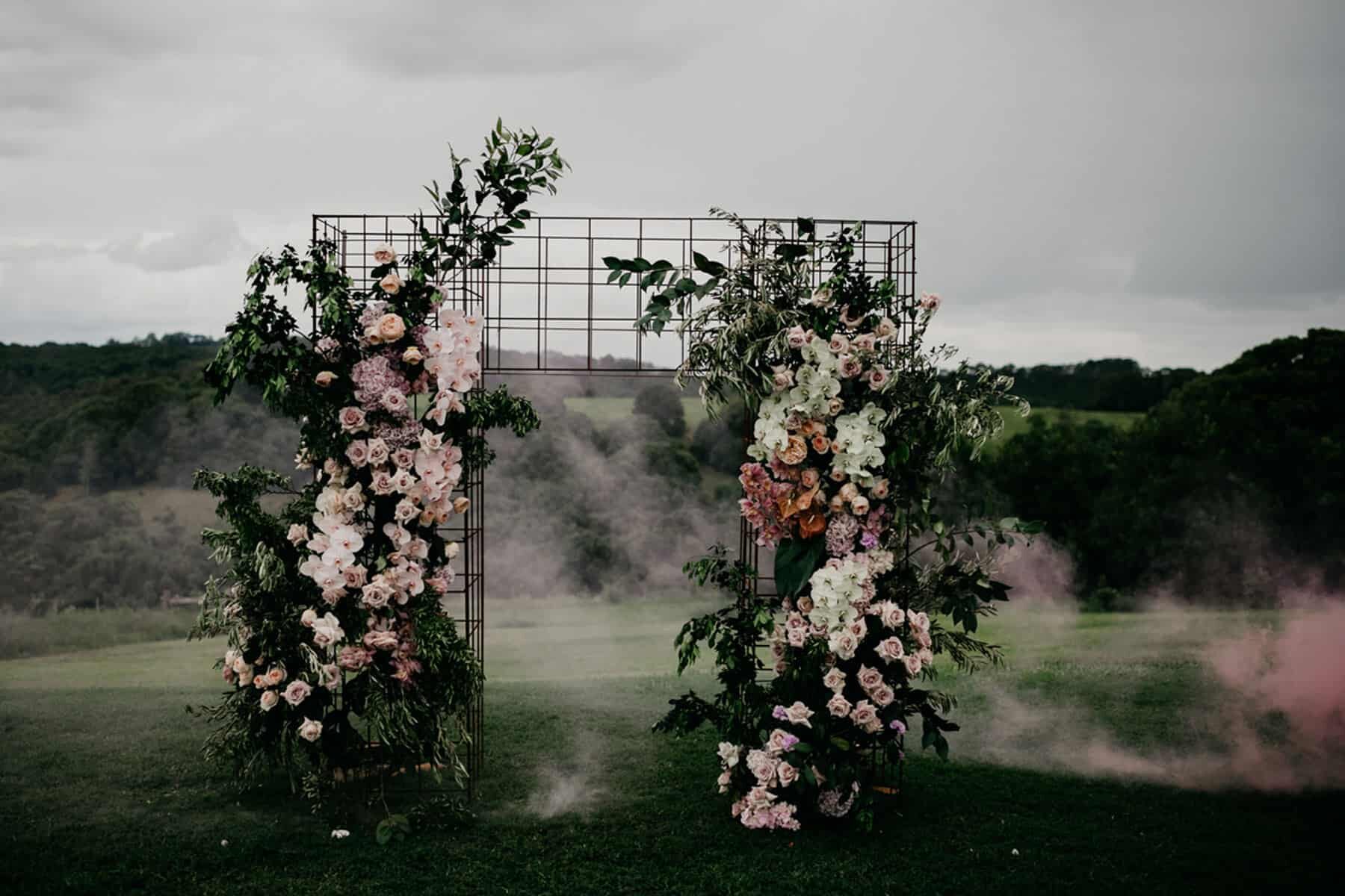 wire floral wedding arch with smoke bomb