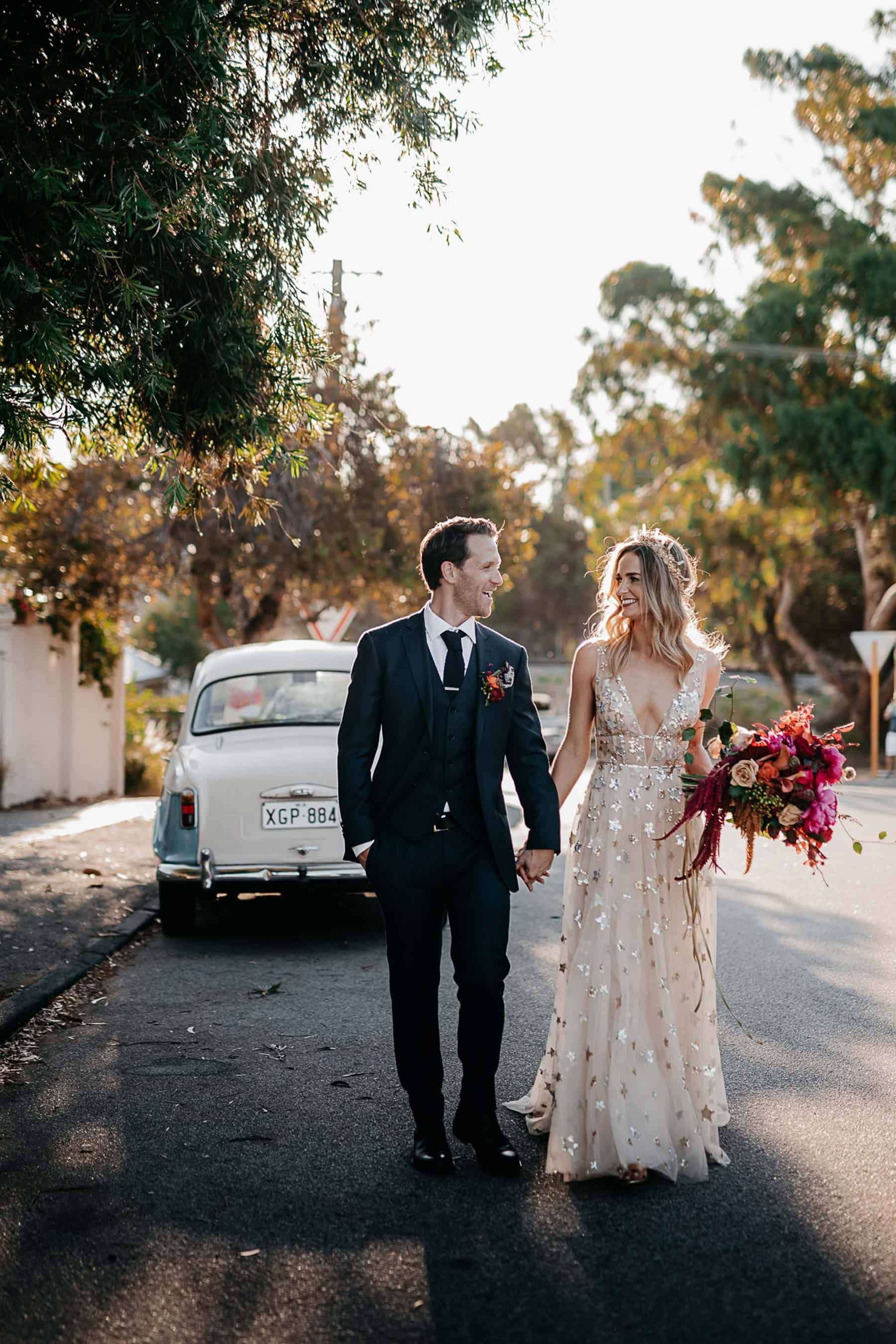 bride wears gold willowby by watters with gold amaroq crown and vibrant pink bouquet for fremantle wedding