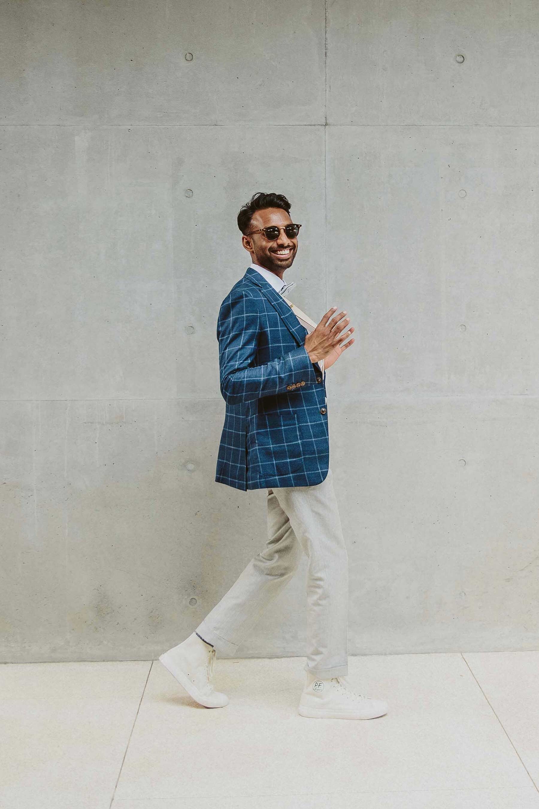 Stylish groom in chinos and checkered blue blazer