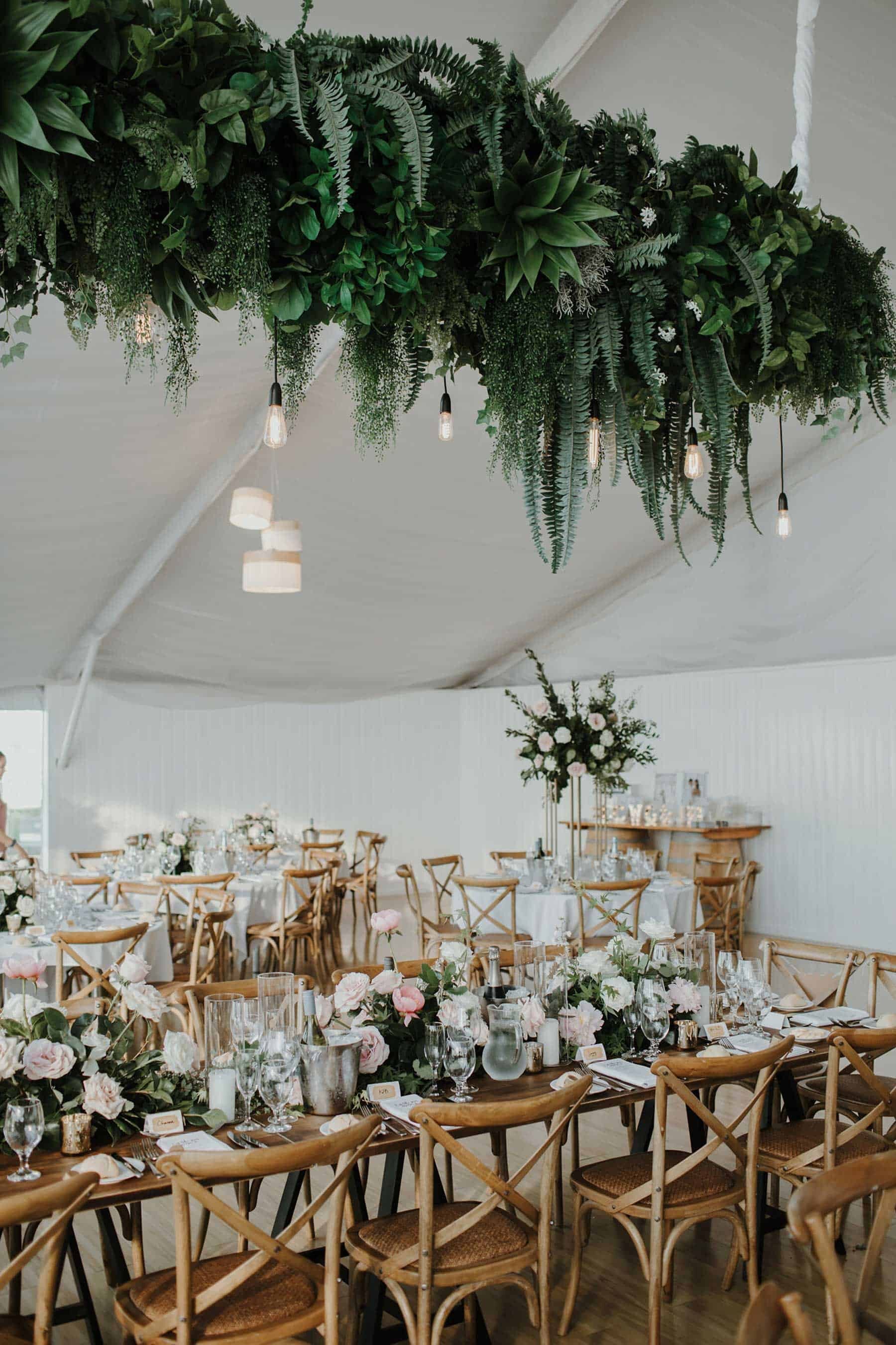 modern marquee wedding with hanging foliage installation