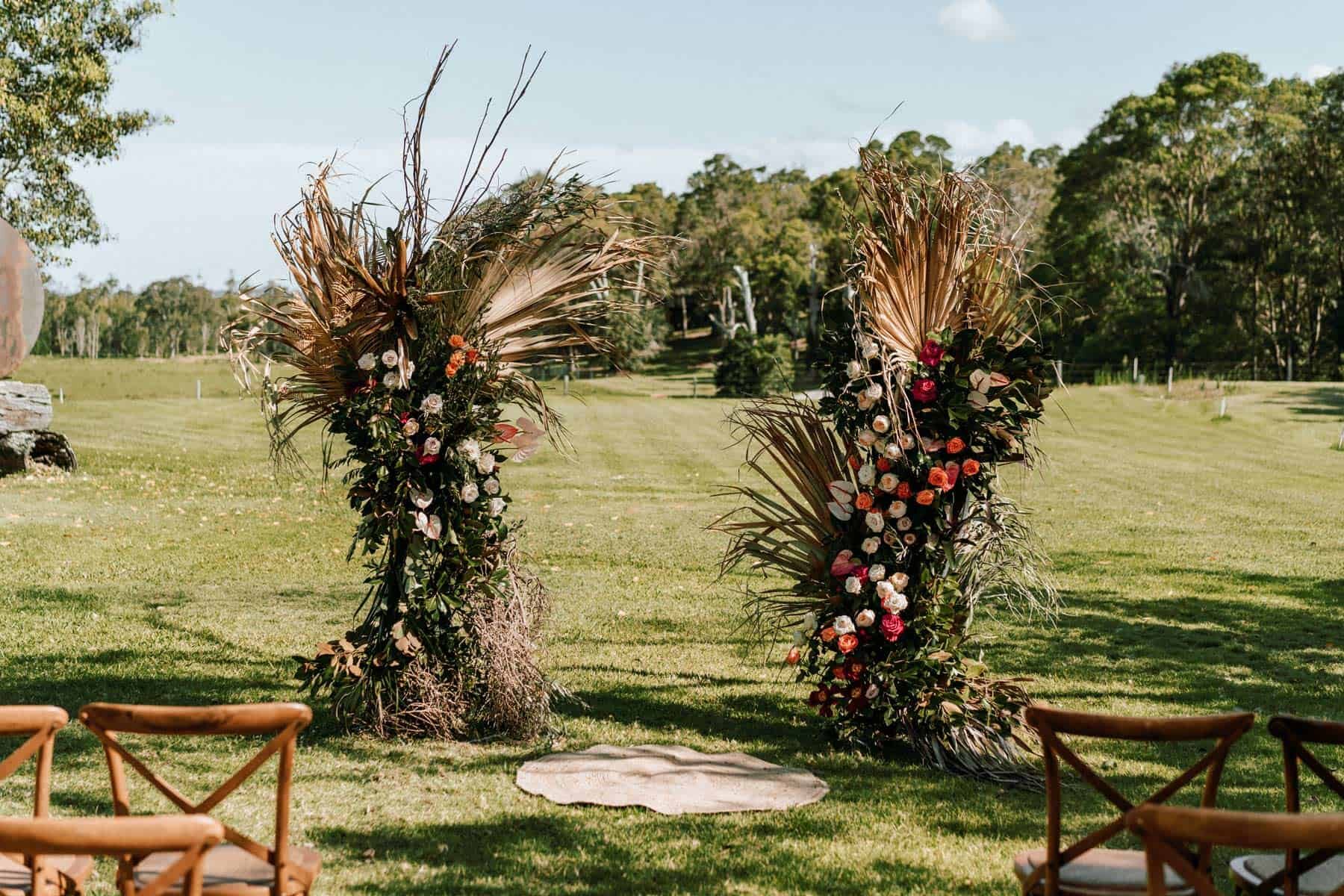 floral arch with dried palm leaves