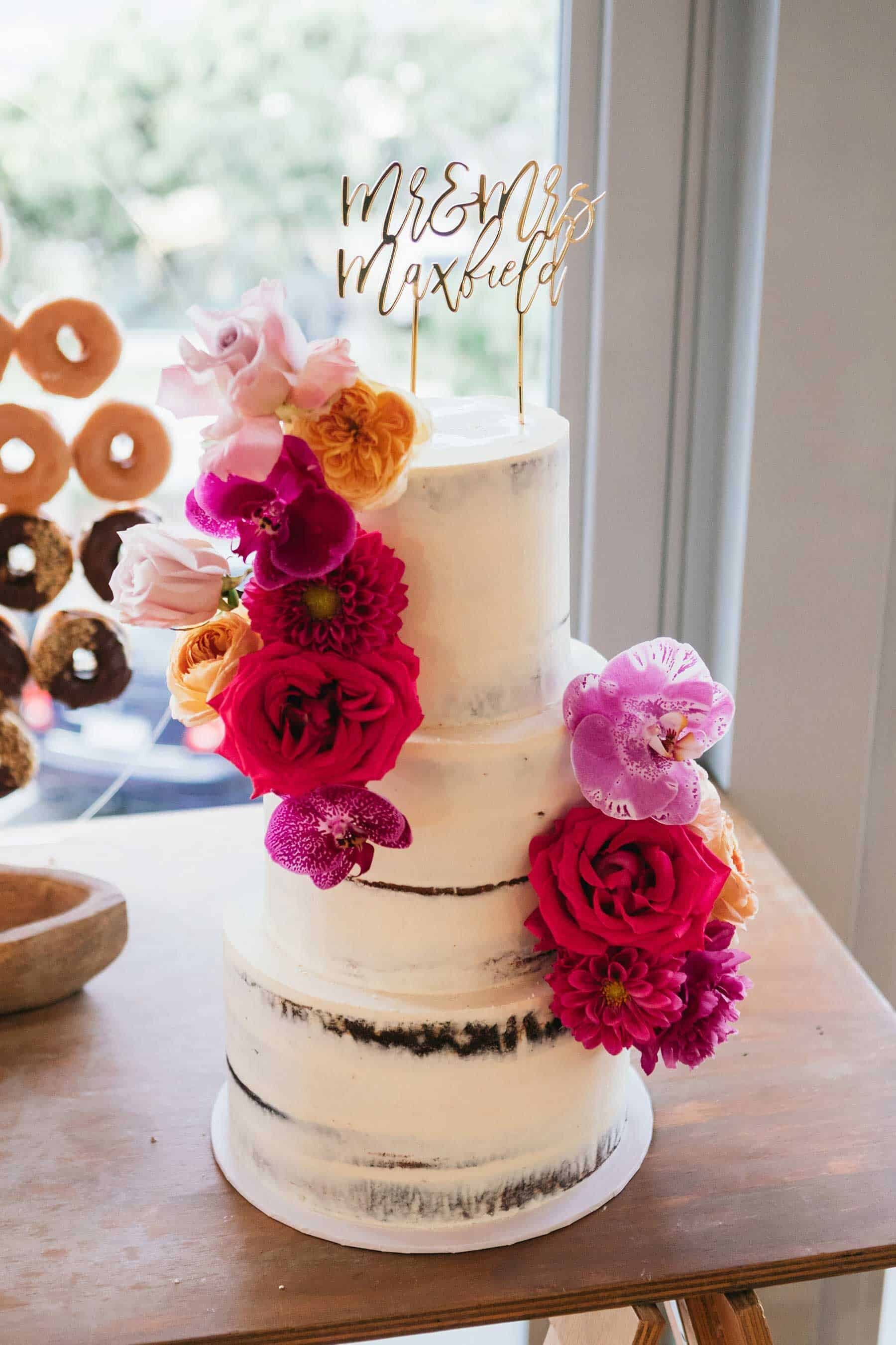 modern wedding cake with bright pink flowers