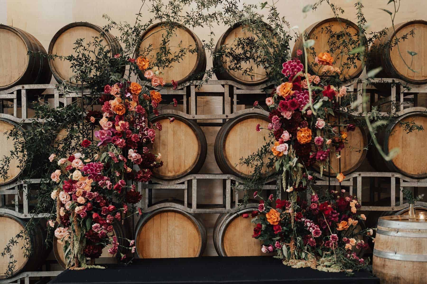 orange and pink floral arch wedding backdrop