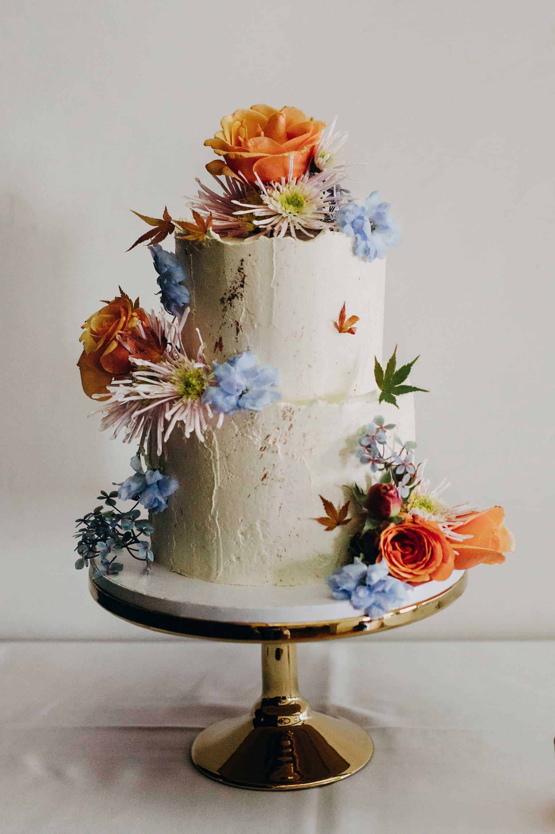 simple rustic wedding cake with fresh flowers