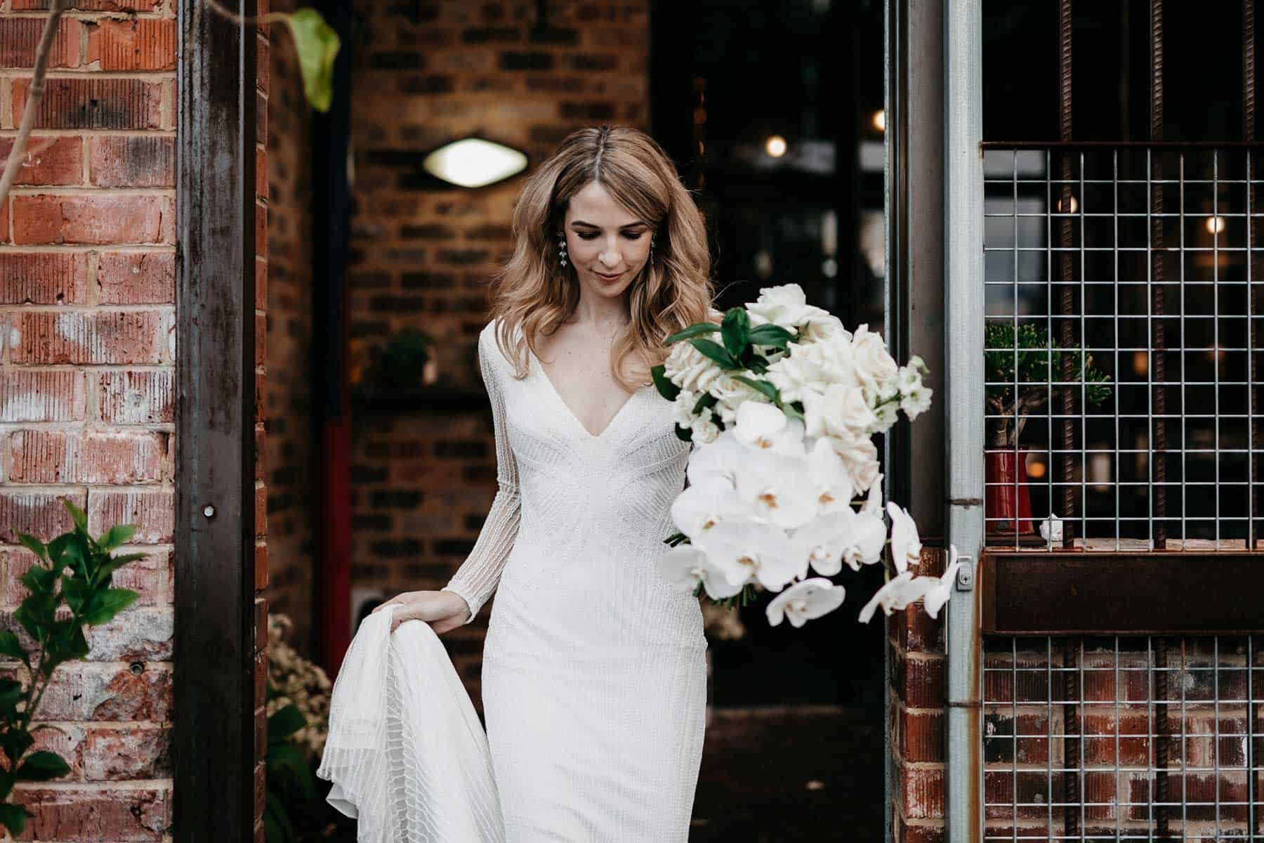 modern classic white bridal bouquet with roses and orchids