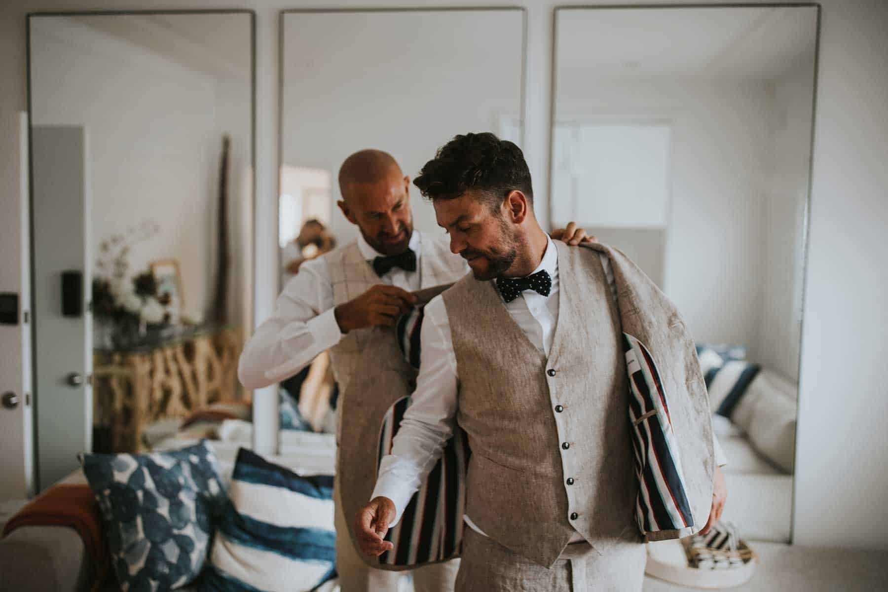 two grooms getting ready together