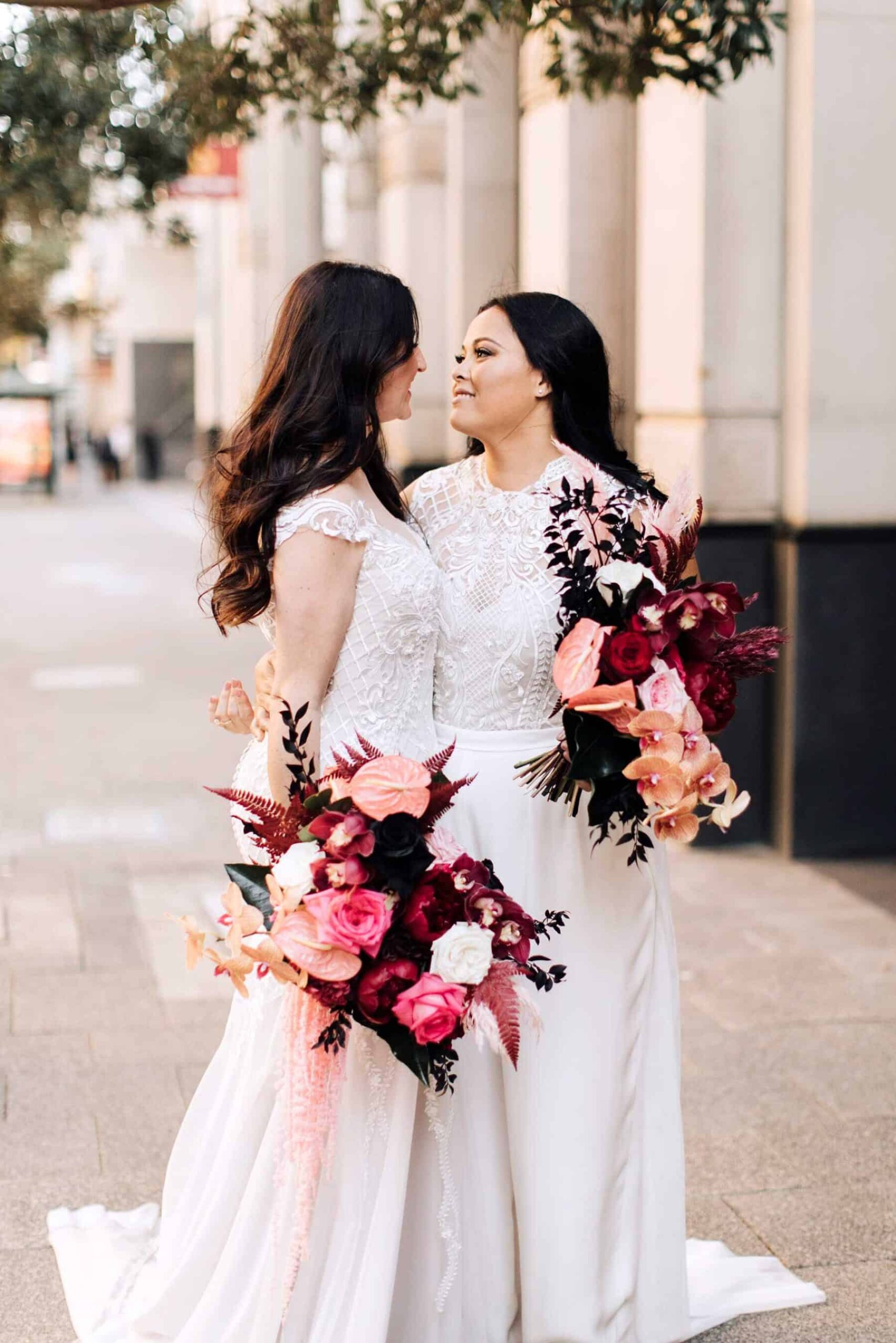 two brides with pink bridal bouquets