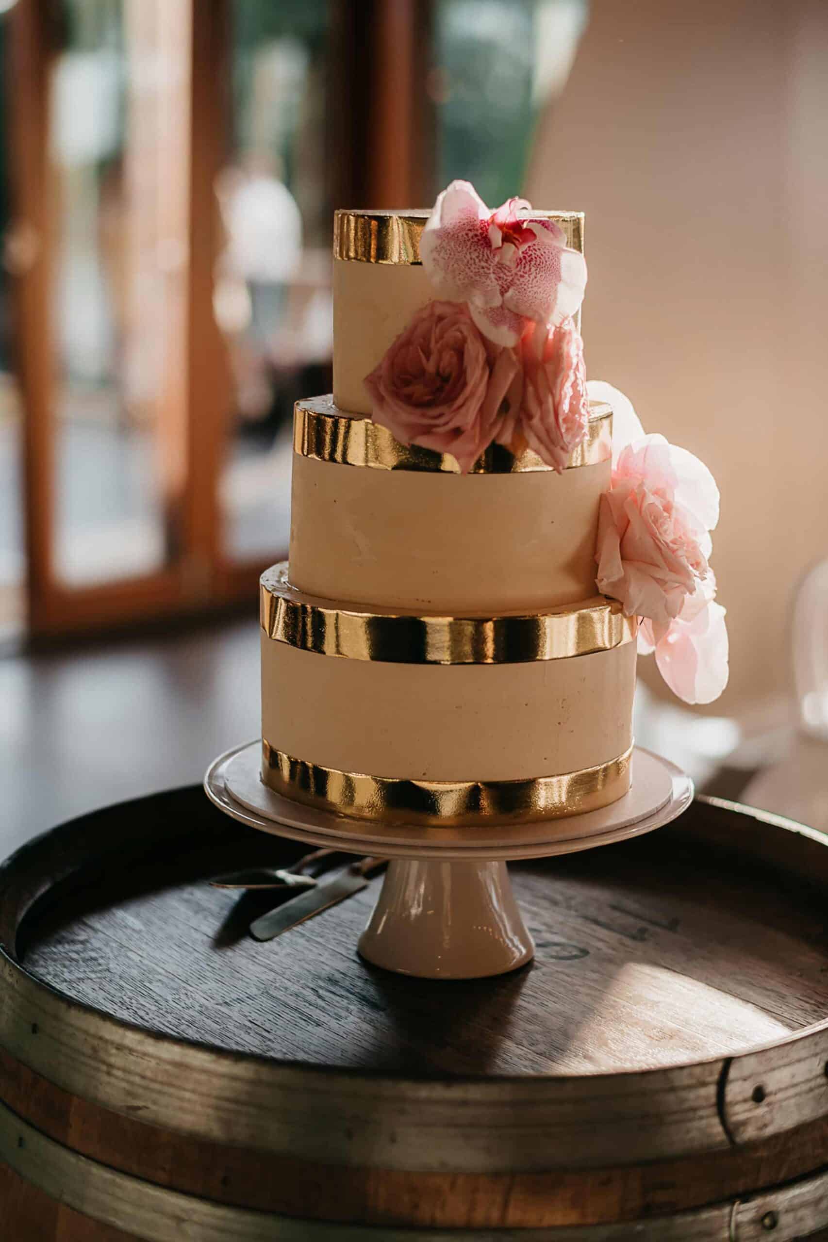 modern three tier wedding cake with gold trim