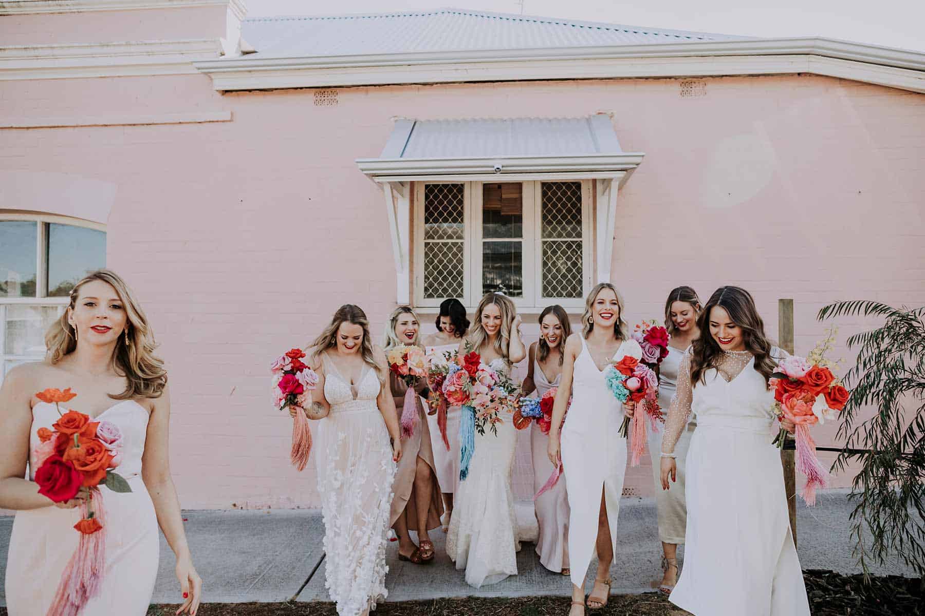 modern bridesmaids in mixed neutrals with colourful bouquets