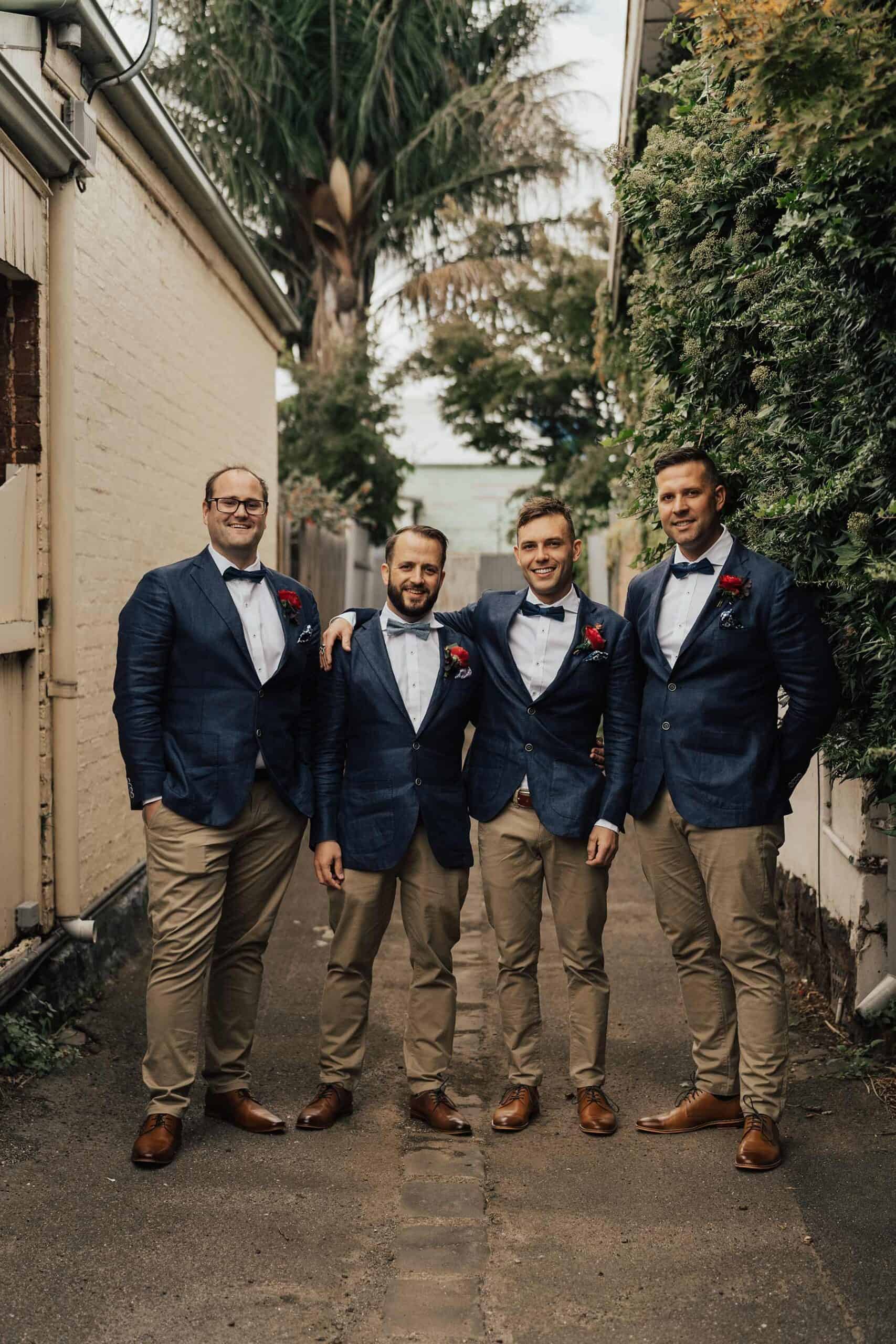 groomsmen in tan chinos and navy blazers