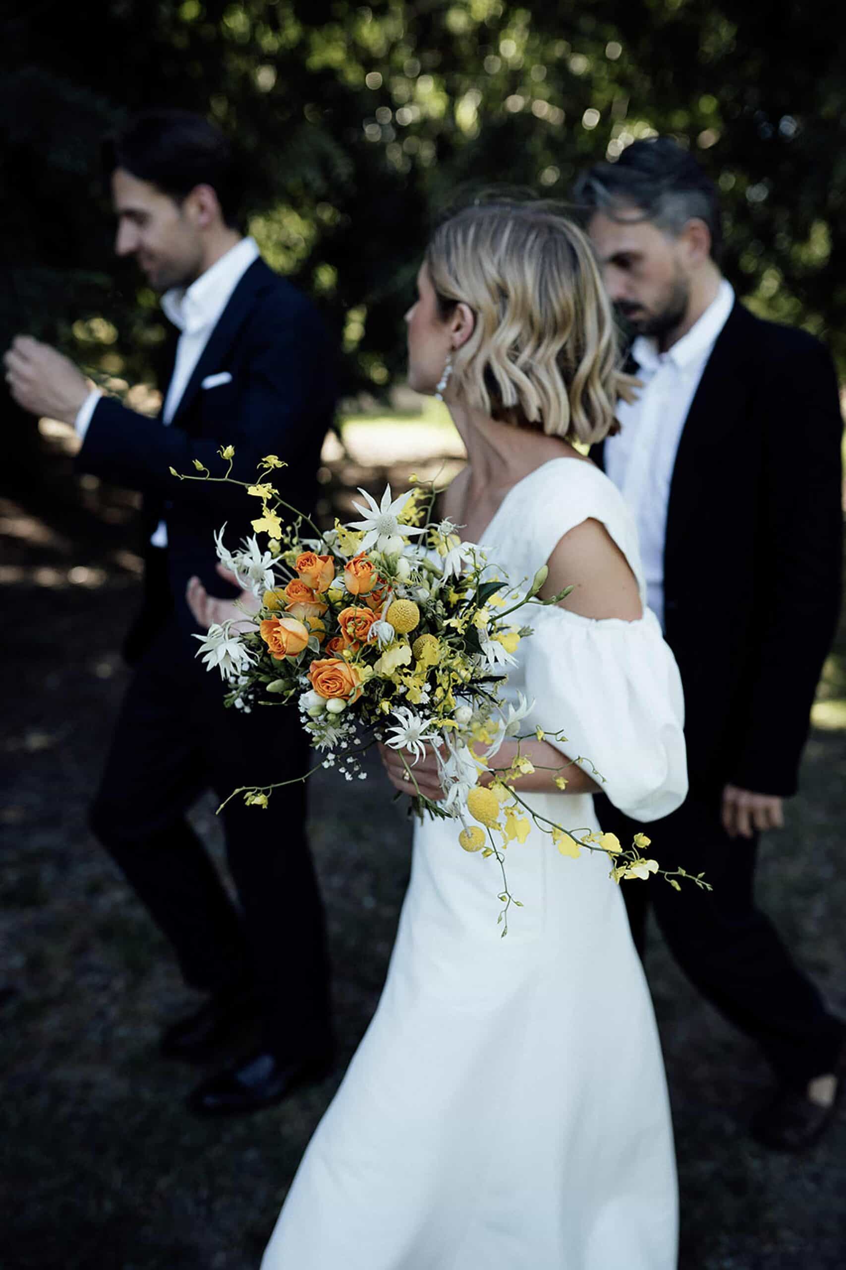 unstructured bridal bouquet with orange roses