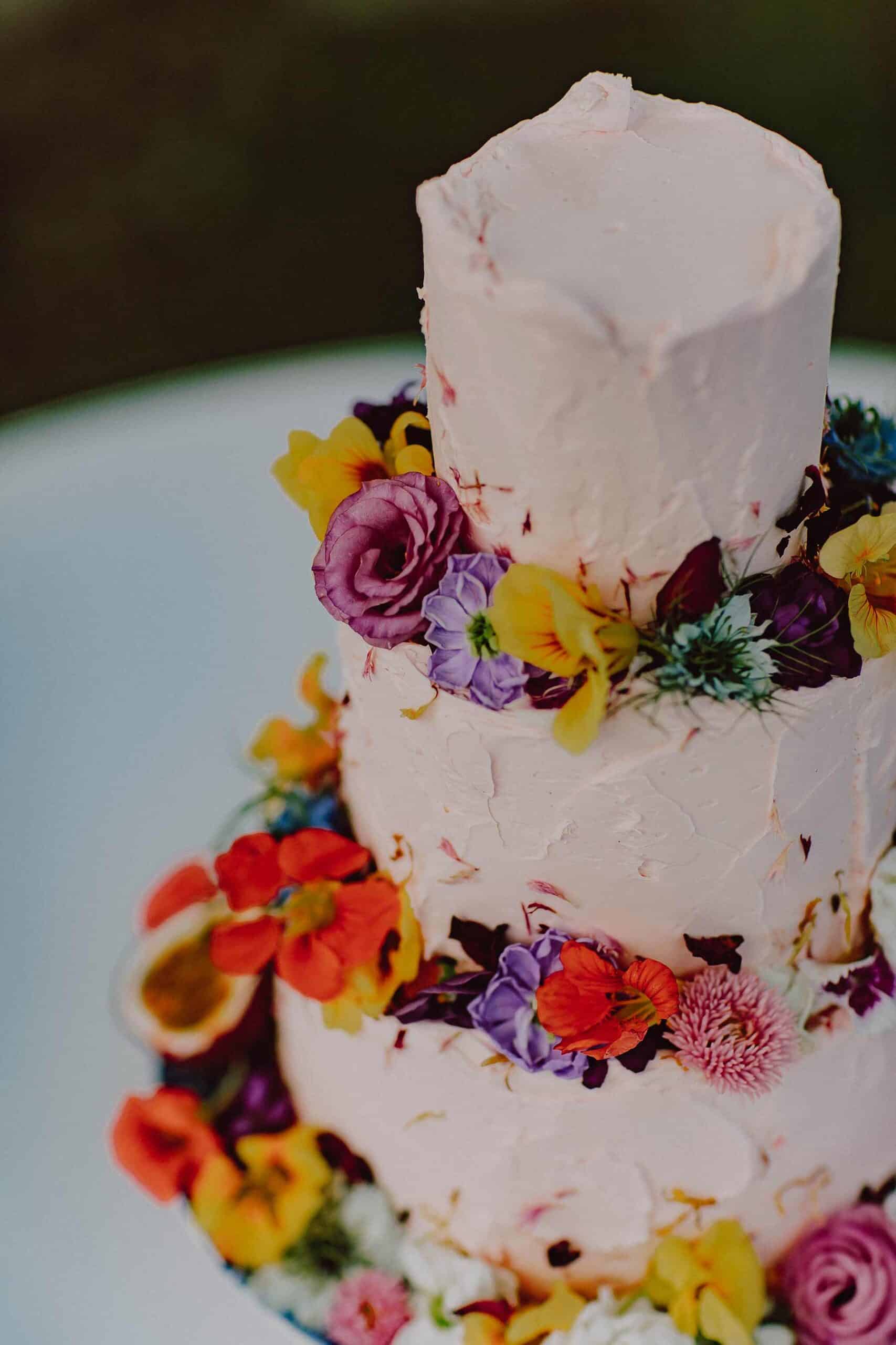three tier buttercream wedding cake with fresh flowers