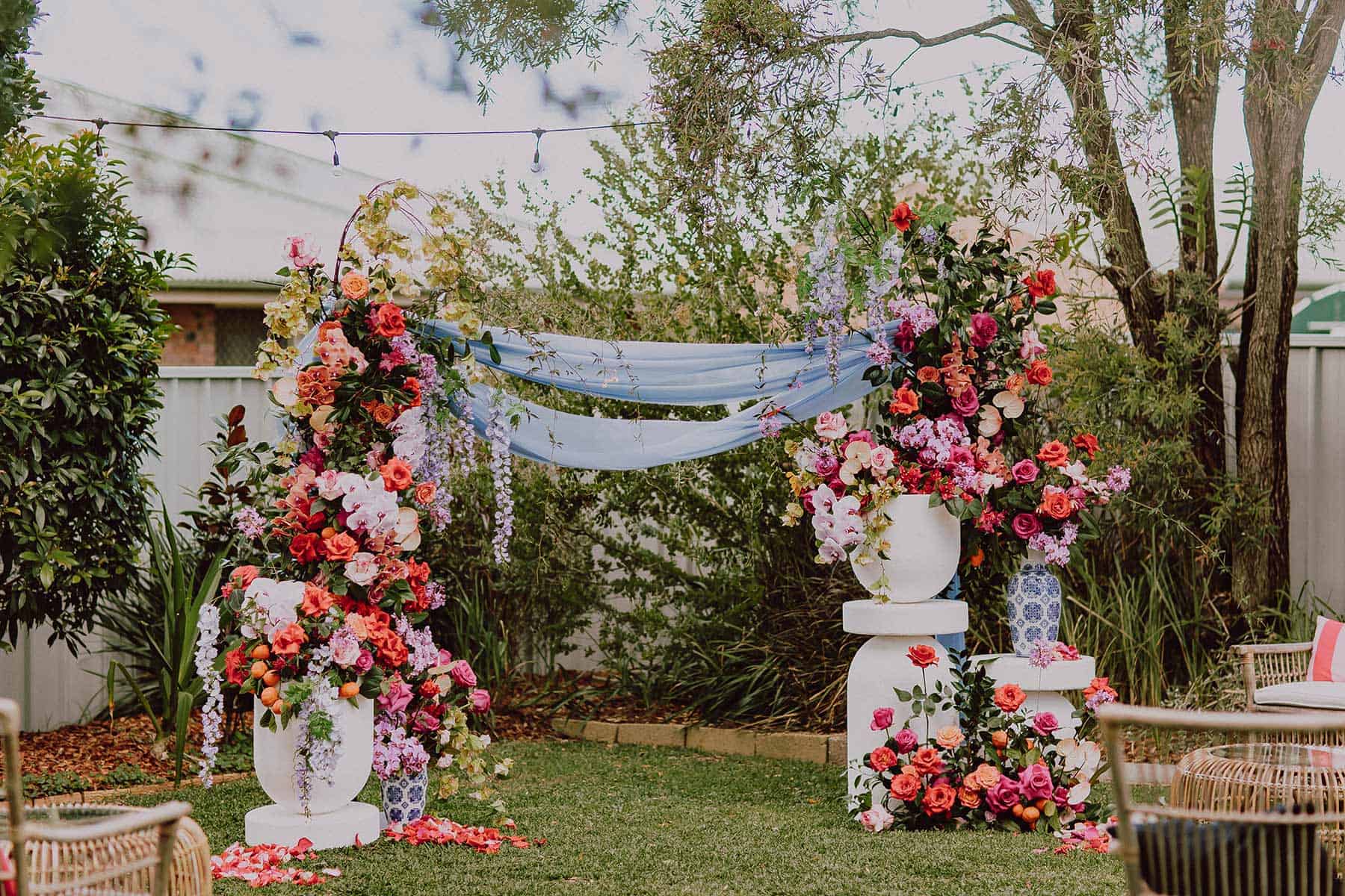 vibrant floral arbour for backyard wedding