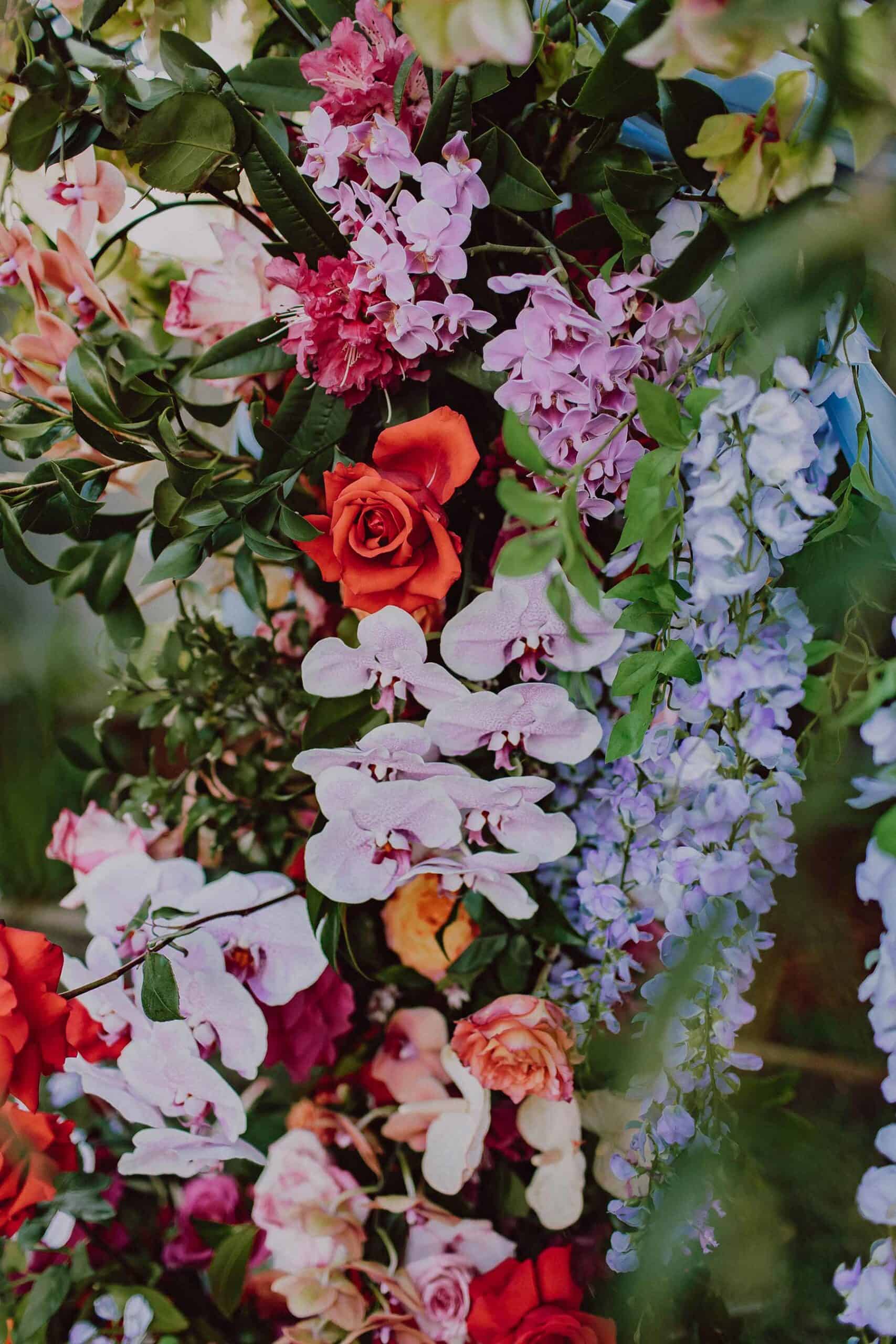 vibrant floral arbour for backyard wedding