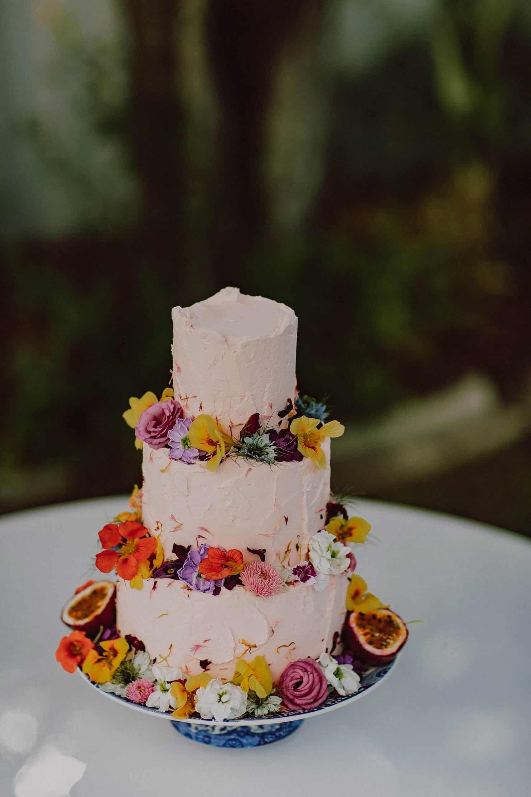 rustic pink three tier wedding cake with edible flowers