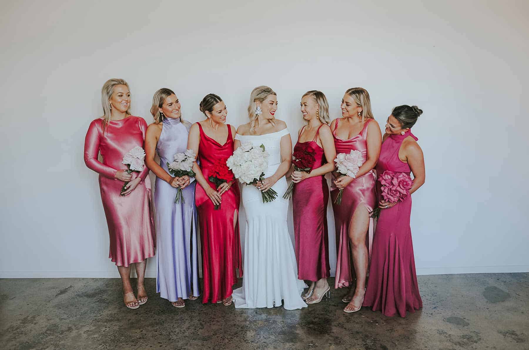 colourful bridesmaids in mixed red and pink dresses